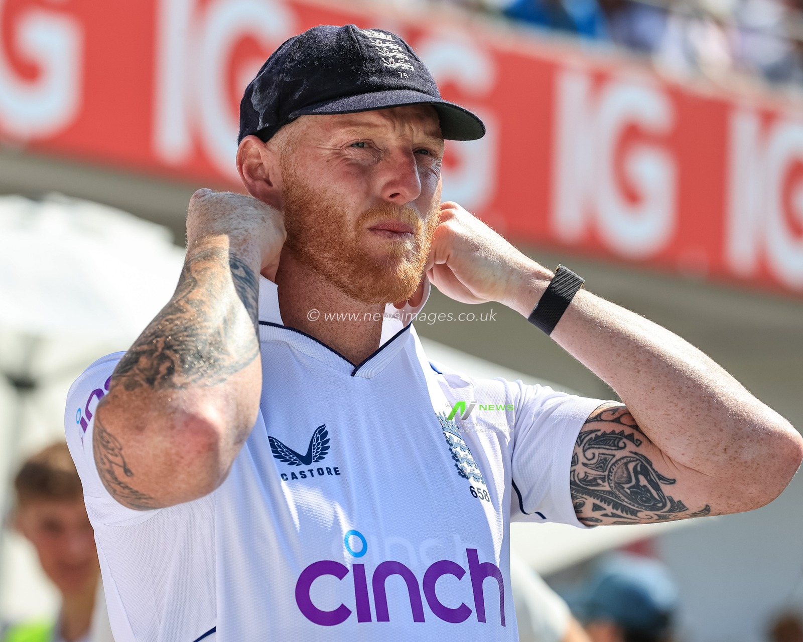 Ben Stokes of England tuns up his collar as he leads England out