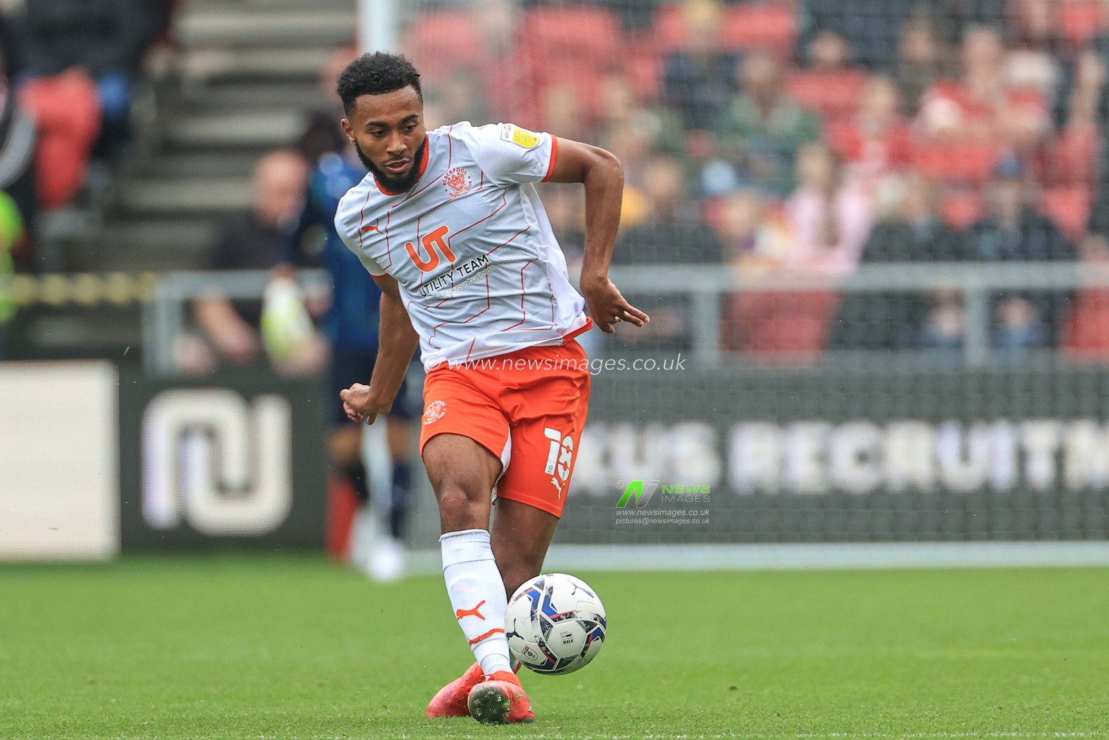 Grant Ward #18 of Blackpool passes the ball