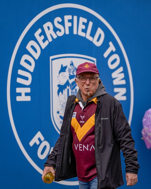 Giants fan walk past a Huddersfield Town FC badge outside the stadium during the Betfred Super League round 7 match Huddersfield Giants vs York Knights at Accu Stadium, Huddersfield, United Kingdom on 04 April 2026

(Photo by Maynard Manyowa/News Images)