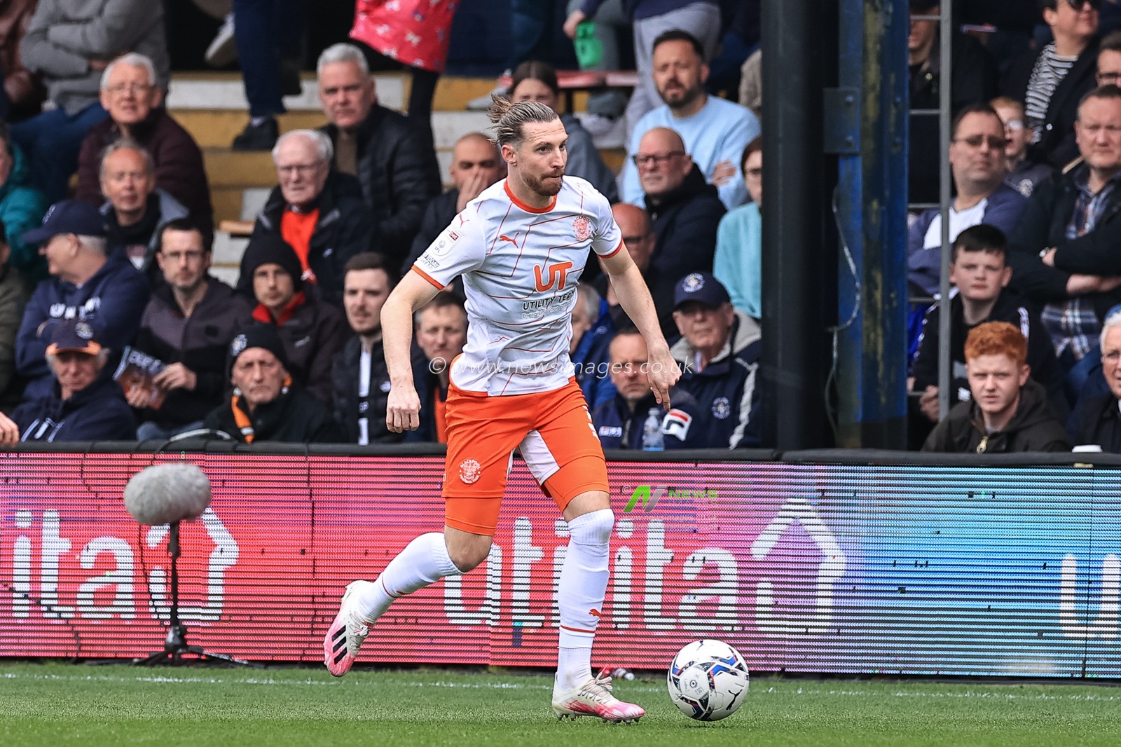 James Husband #3 of Blackpool breaks with the ball