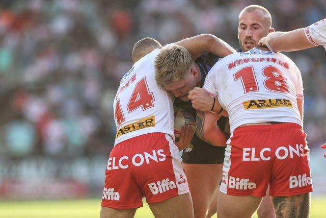 James McDonnell of Leeds Rhinos is tackled by Moses Mbye of St. Helens and Jake Wingfield of St. Helens during the Betfred Super League round 15 match St Helens vs Leeds Rhinos at Totally Wicked Stadium, St Helens, United Kingdom, 20th June 2025

(Photo by Alfie Cosgrove/News Images)