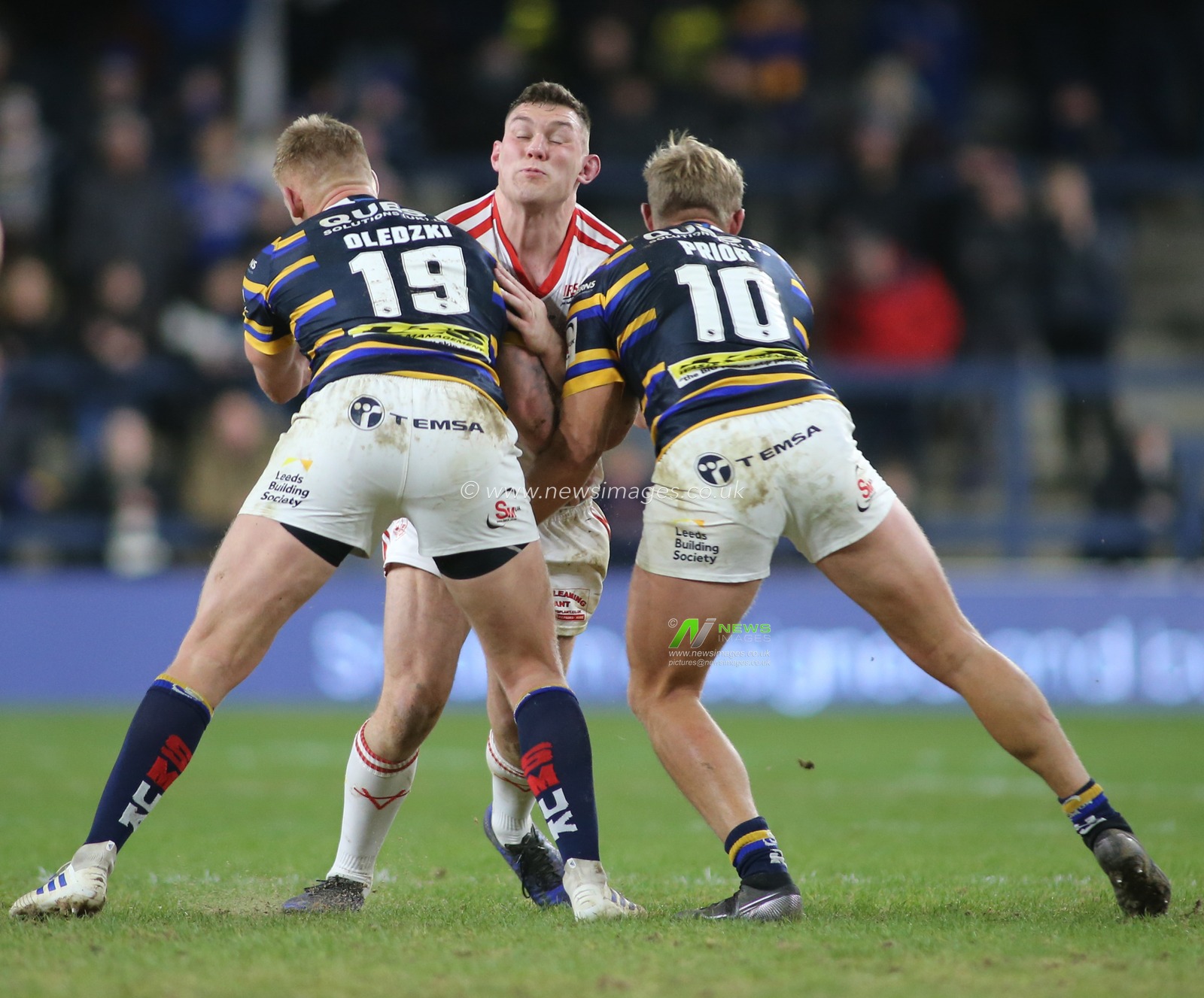 14th February 2020, Headingley Carnegie Stadium, Leeds, England; Betfred Super League, Leeds Rhinos v Hull Kingston Rovers : Robbie Mulhern (C) of Hull KR tackled by Mikolaj Oledzki (L) and Matt Prior (R) of Leeds Rhinos.