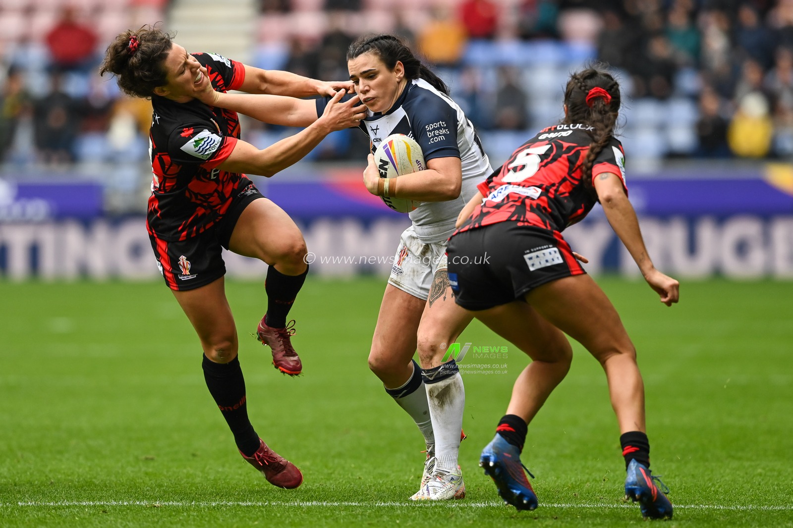 Carrie Roberts of England fends off Gabrielle Hindley of Canada  during the Women's Rugby League World Cup match England Women vs Canada Women at DW Stadium, Wigan, United Kingdom, 5th November 2022

(Photo by Craig Thomas/News Images)