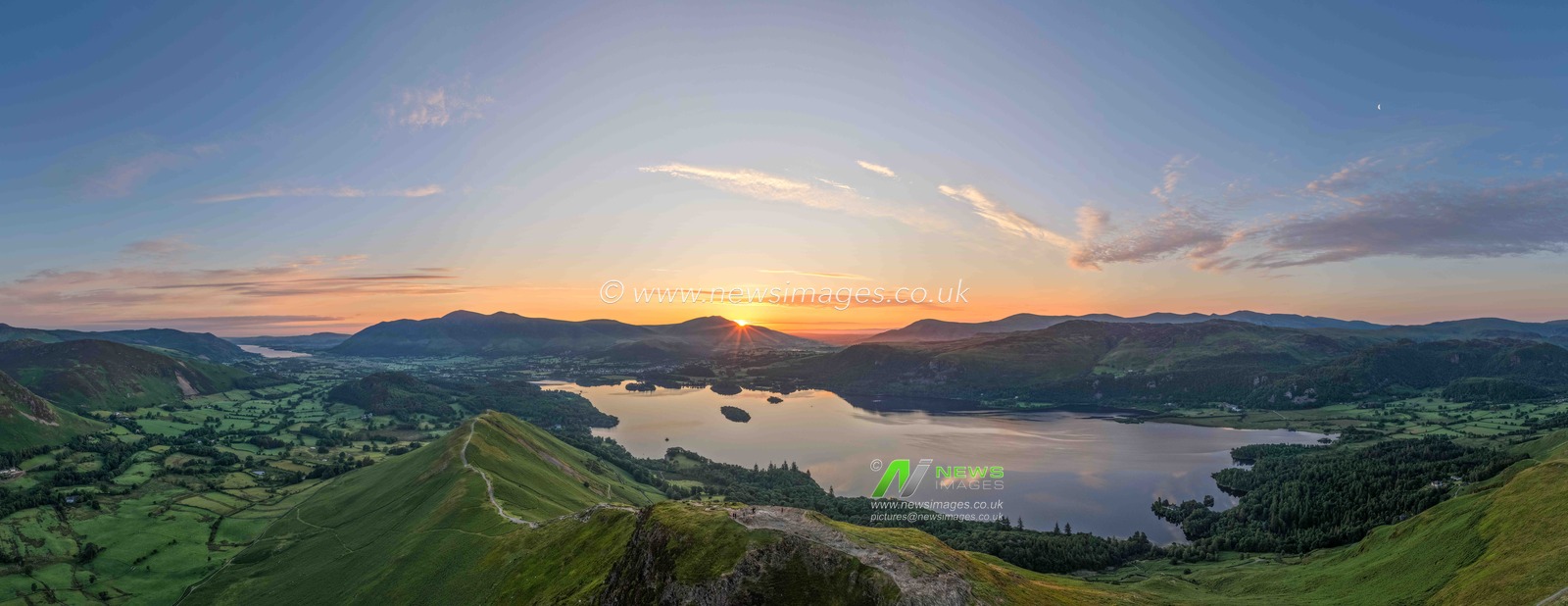 Photographers take pictures as the sun rises from the summit of Catbells overlooking Derwent Water and the town of Keswick In the Lake District, Cumbria, United Kingdom, 19th June 2025

*** EDITORS NOTE THIS IS A PANO MADE UP OF 9 IMAGES ***

(Photo by Mark Cosgrove/News Images)