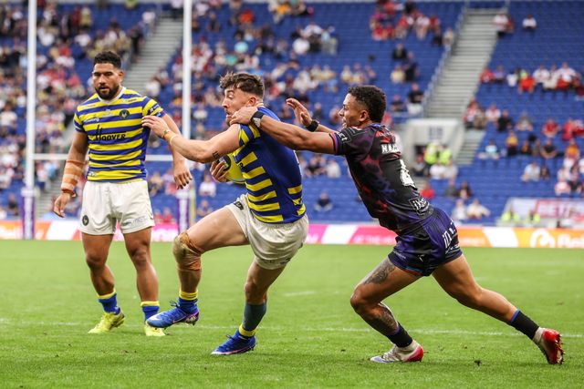 Matty Ashton of Warrington Wolves is tackled by Umyla Hanley of Leigh Leopards during the Betfred Super League Magic Weekend match Leigh Leopards vs Warrington Wolves at Leigh Sports Village, Leigh, United Kingdom on 04 July 2026

(Photo by Alfie Cosgrove/News Images)