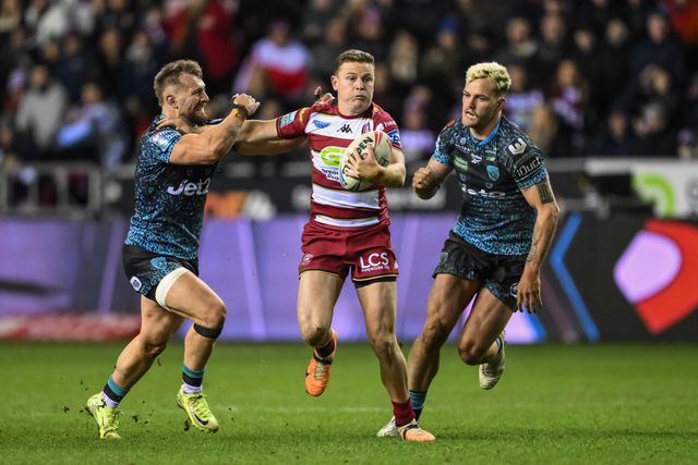 Jai Field of Wigan Warriors fends off Matty Davis of Leigh Leopards during the Betfred Super League Round 1 match Wigan Warriors vs Leigh Leopards at The Brick Community Stadium, Wigan, United Kingdom, 13th February 2025

(Photo by Craig Thomas/News Images)