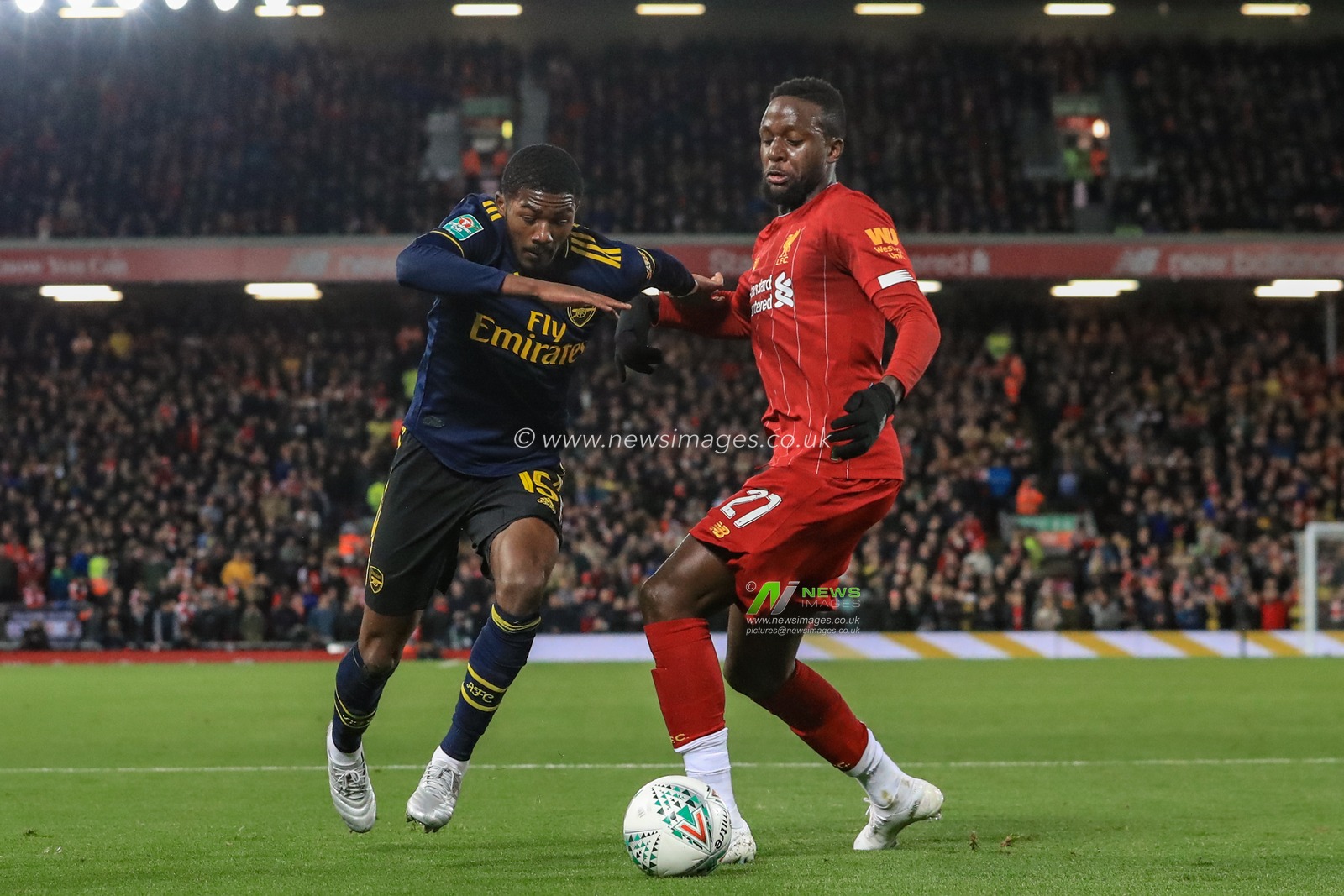 30th October 2019, Anfield, Liverpool, England; Carabao Cup, Liverpool v Arsenal : Divock Origi (27) of Liverpool and Ainsley Maitland-Niles (15) of Arsenal dual for the ball 

Credit: Mark Cosgrove/News Images