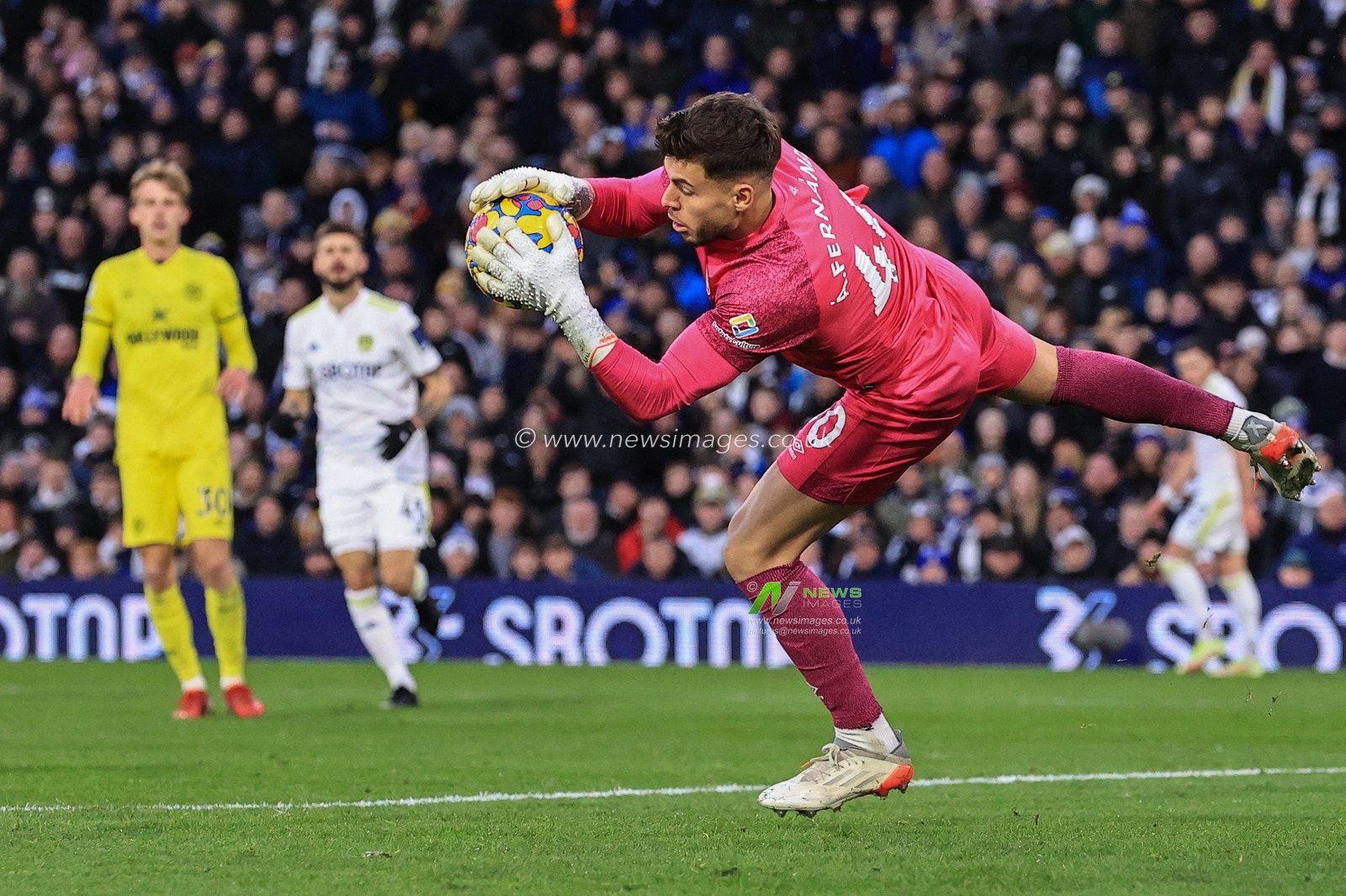 Ãlvaro Fernandez #40 of Brentford saves a shot off Stuart Dallas #15 of Leeds United