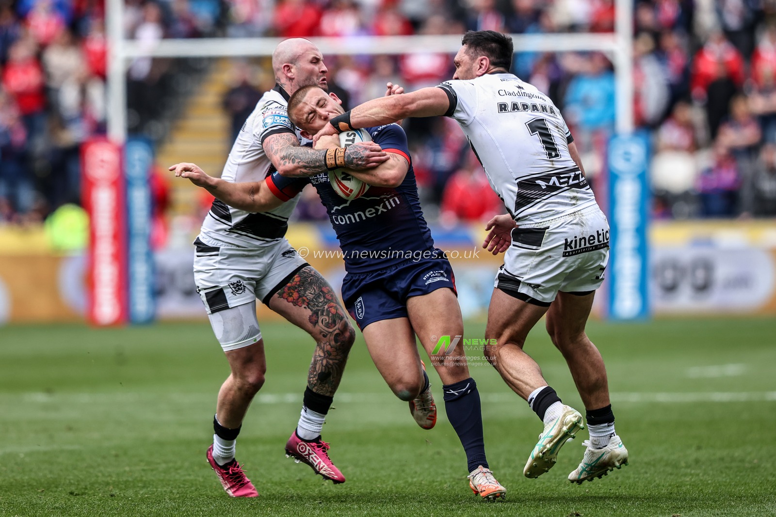 Mikey Lewis of Hull KR is tackled by Jordan Rapana of Hull FC and Zak Hardaker of Hull FC during the Betfred Super League Round 8 match Hull FC vs Hull KR at MKM Stadium, Hull, United Kingdom, 18th April 2025

(Photo by Alfie Cosgrove/News Images)