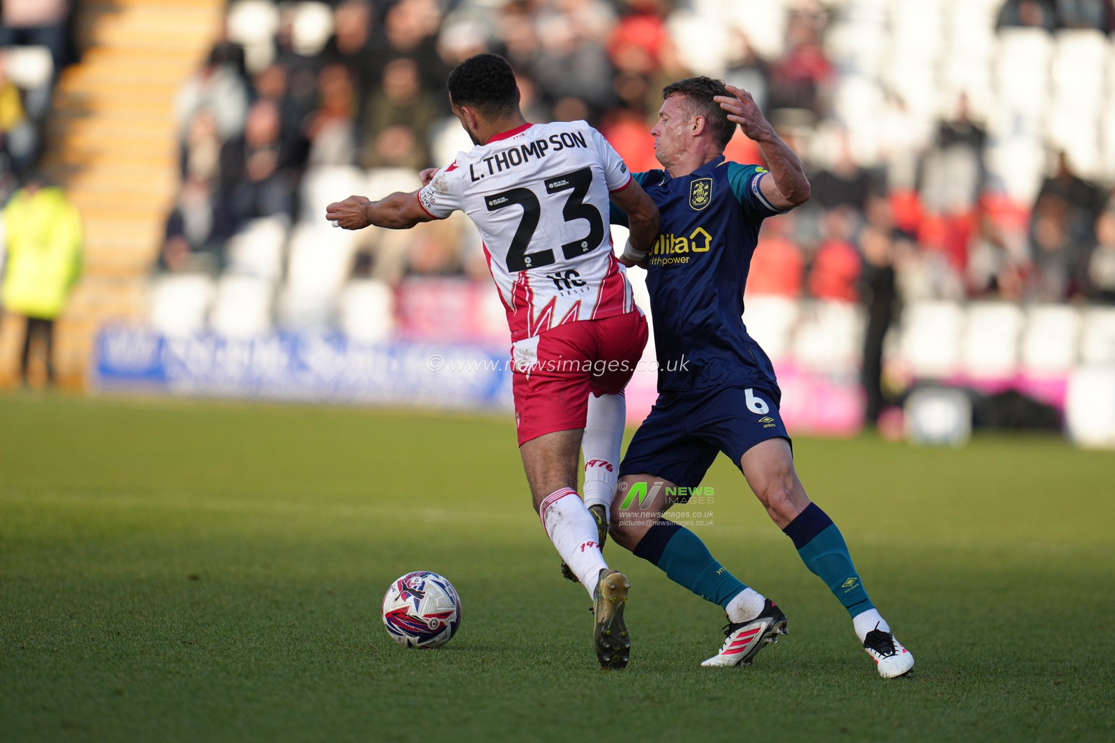 Jonathan Hogg of Huddersfield Town holds Louis Thompson of Stevenage back during the Sky Bet League 1 match Stevenage vs Huddersfield Town at Lamex Stadium, Stevenage, United Kingdom, 1st March 2025

(Photo by Harvey Murphy/News Images)