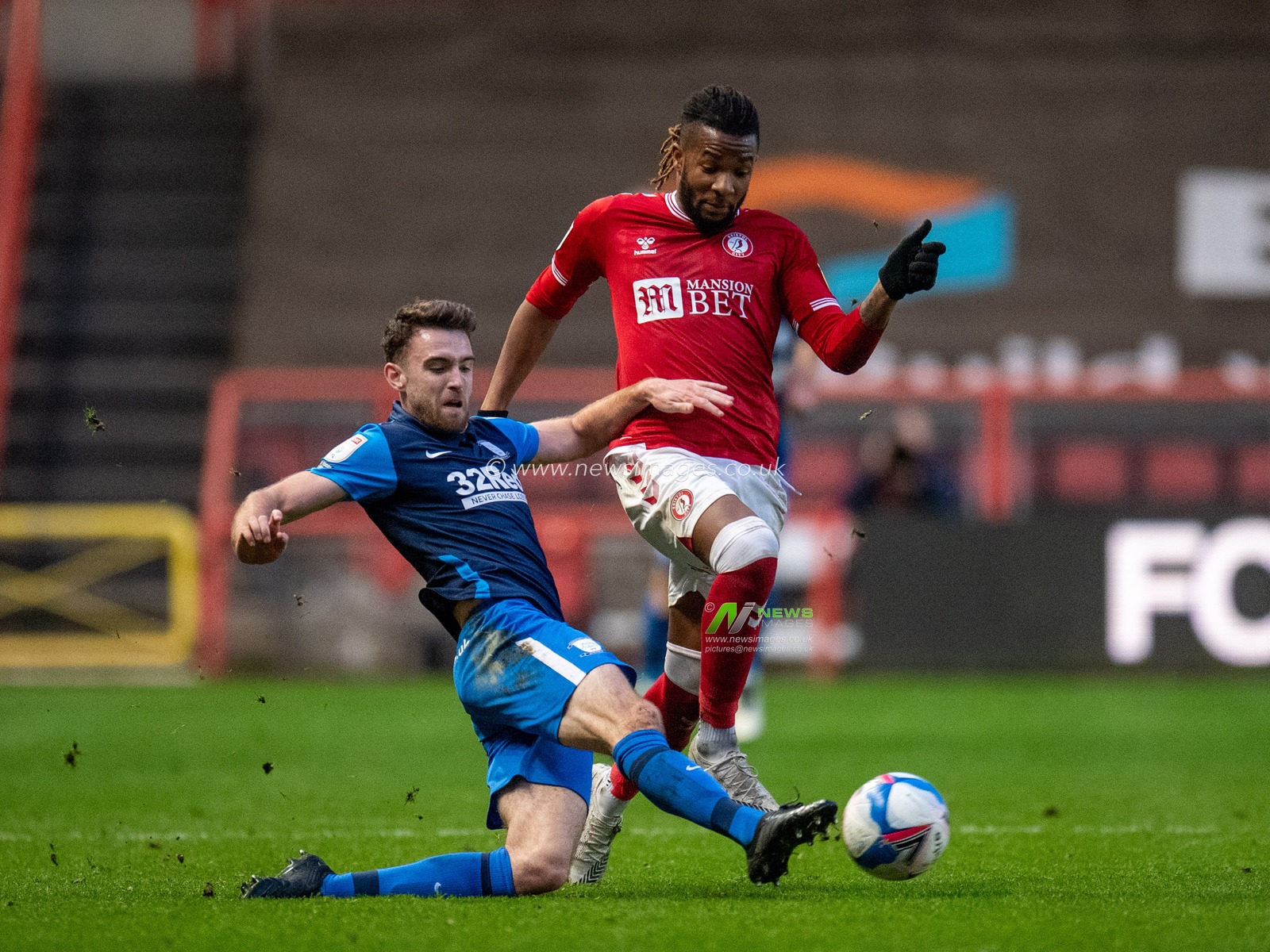 Ben Whiteman #17 of Preston North End slides to win the ball against Kasey Palmer #45 of Bristol City