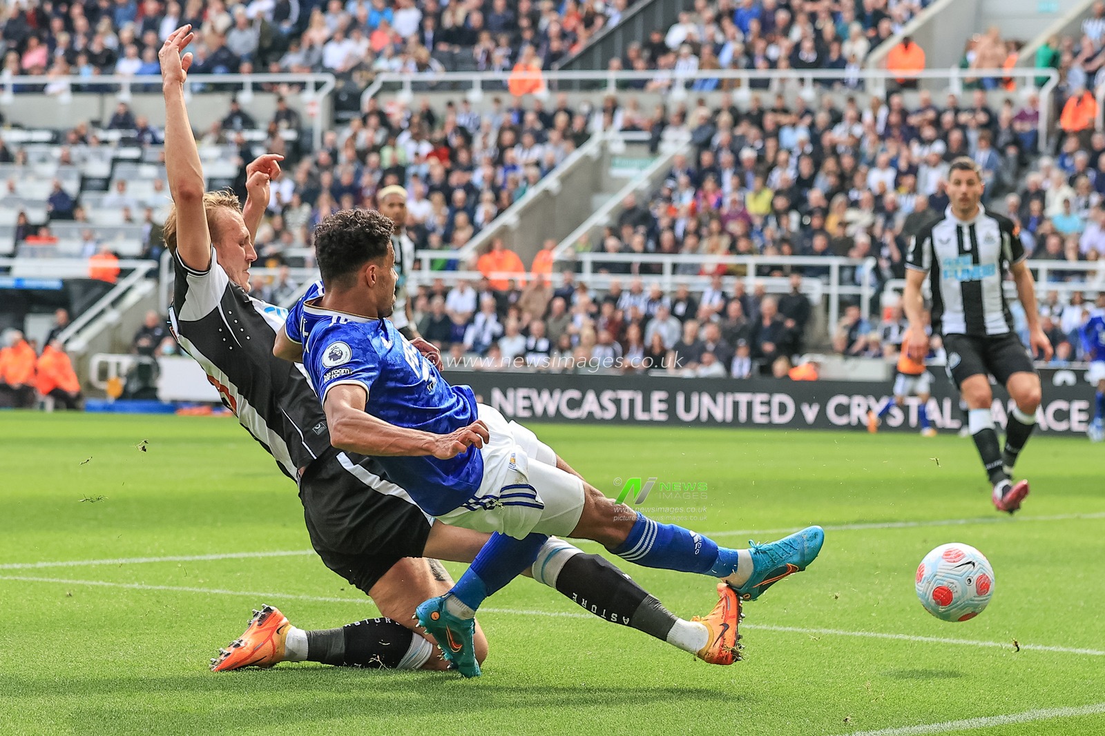 Dan Burn #33 of Newcastle United tackles James Justin #2 of Leicester City as he attempts a shot on goal