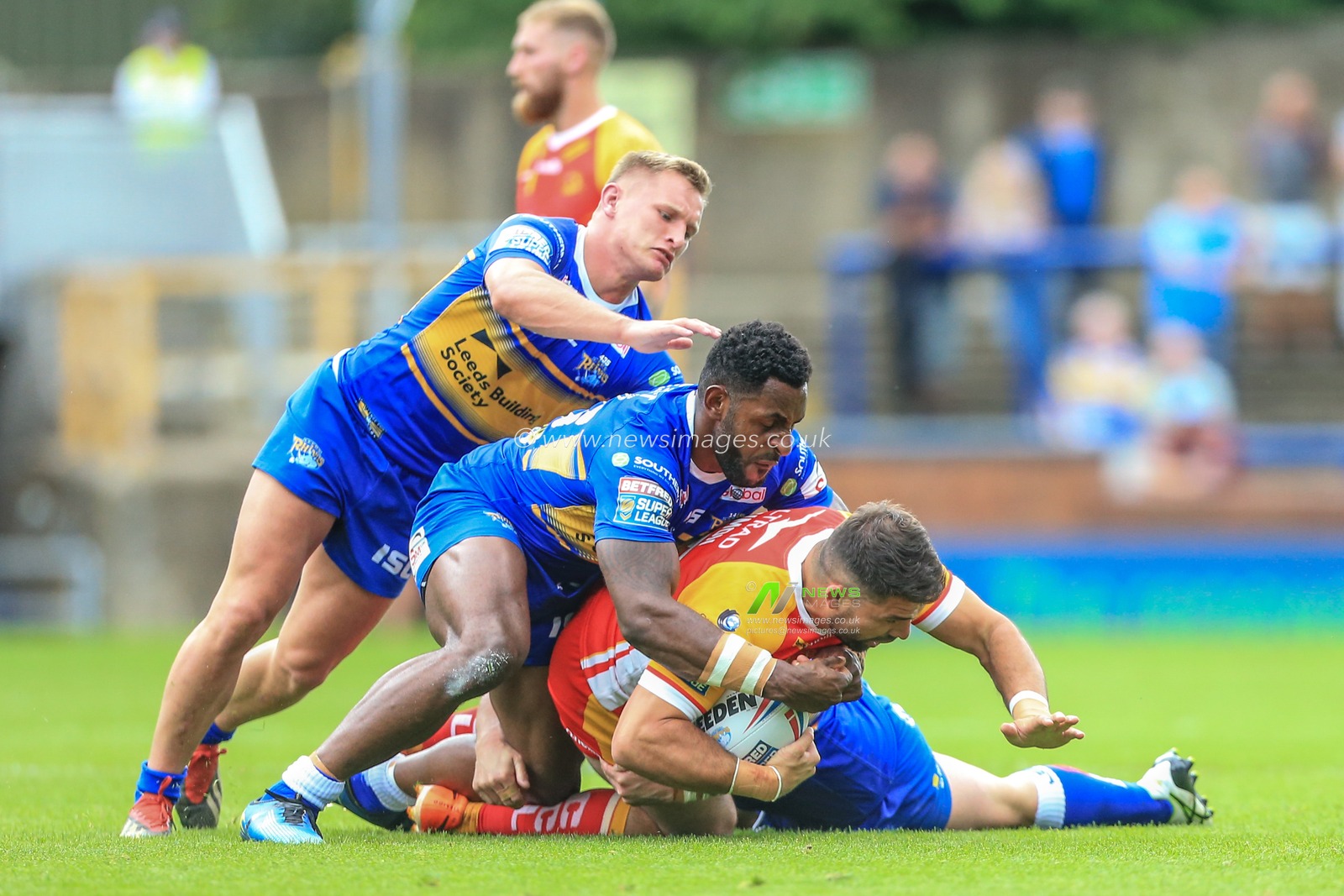 30th June 2019 , Emerald Headingley Stadium, England; Betfred Super League, Round 20, Leeds Rhinos vs Catalans Dragons ; Mickael Simon (15) of Catalans Dragons is tackled by Wellington Albert (36) of Leeds Rhinos 


Credit: Mark Cosgrove/News Images