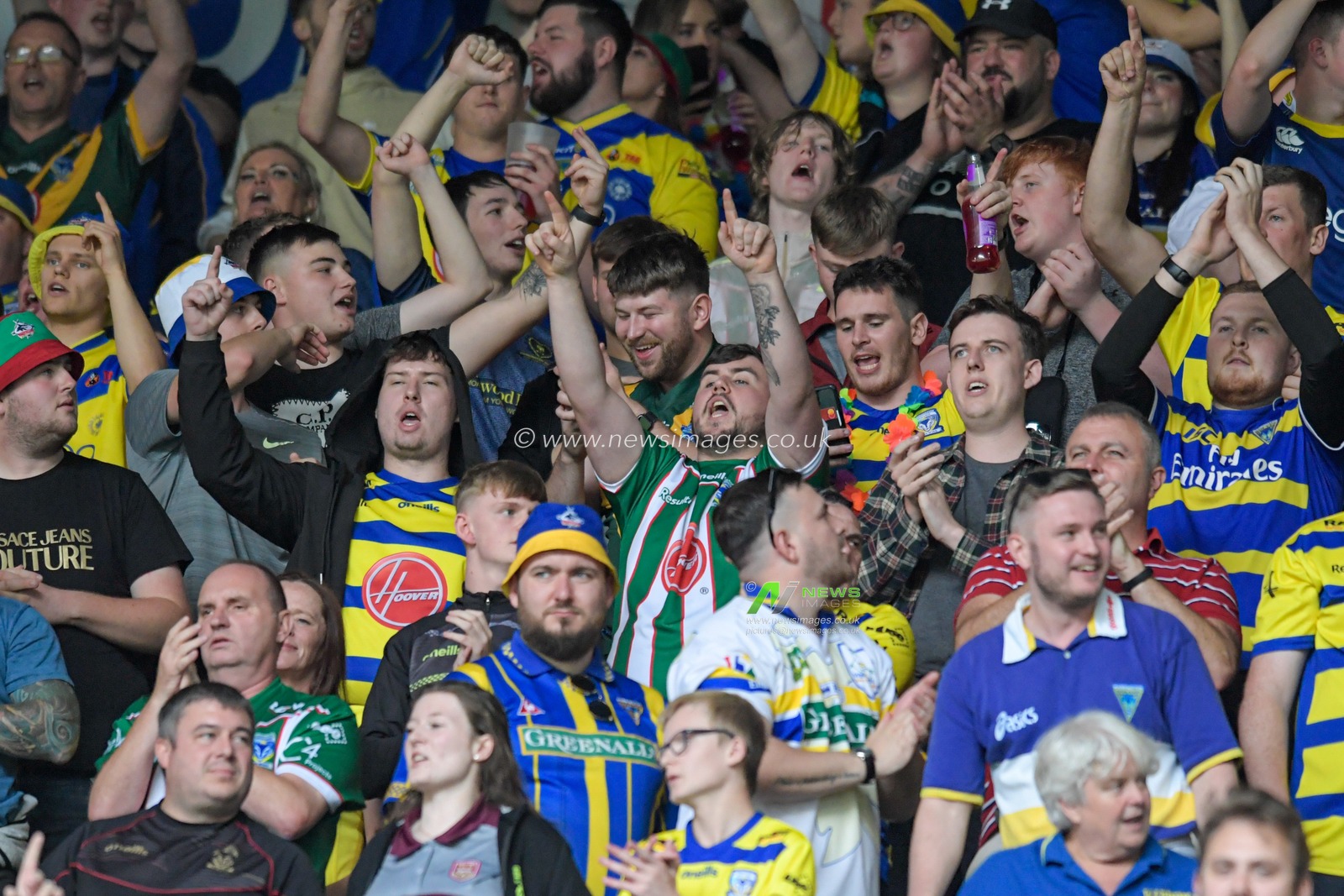 The Warrington Wolves fans celebrate beating Wigan Warriors 6-10