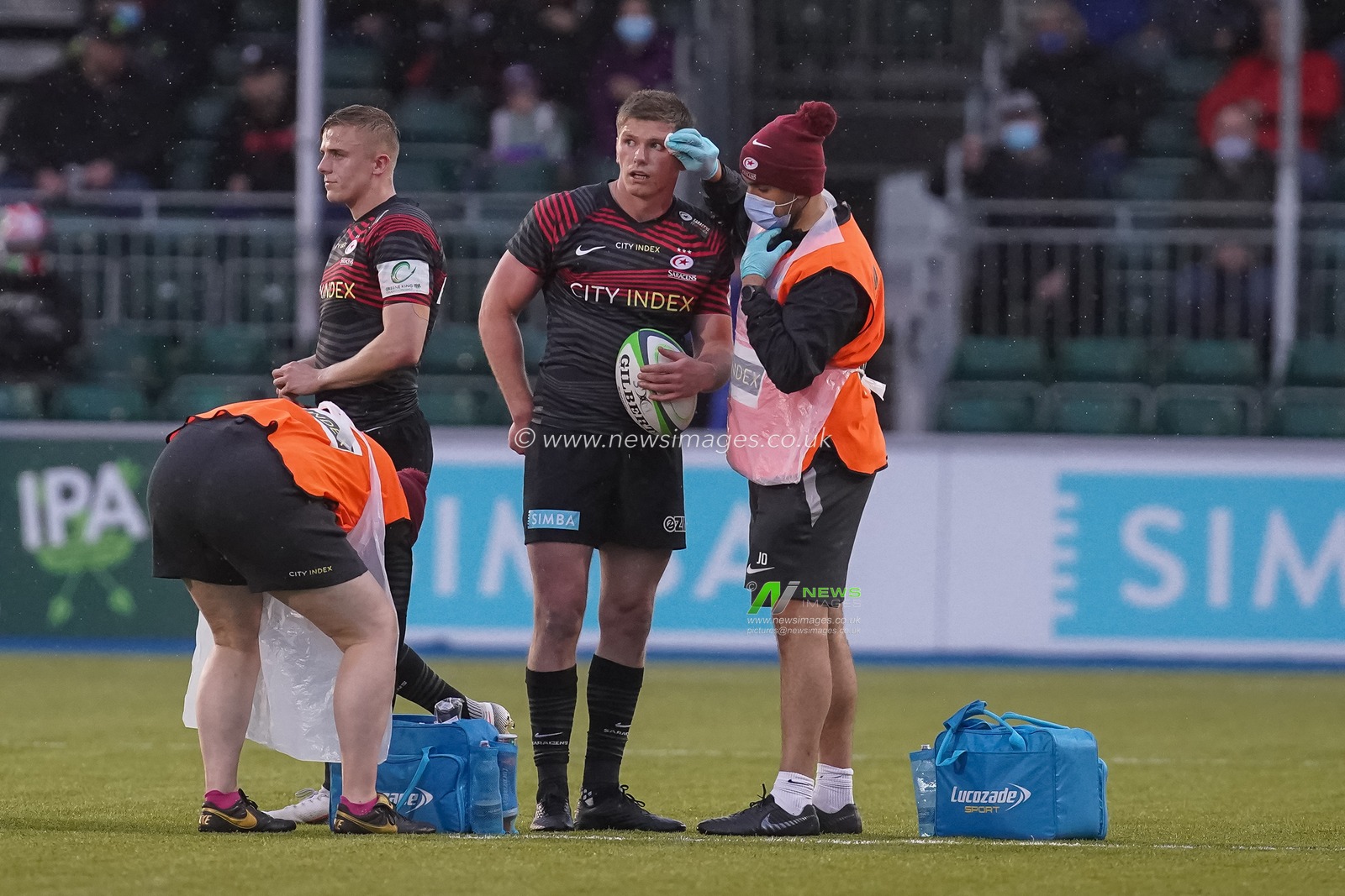 Owen Farrell #10 of Saracens receives medical assistance