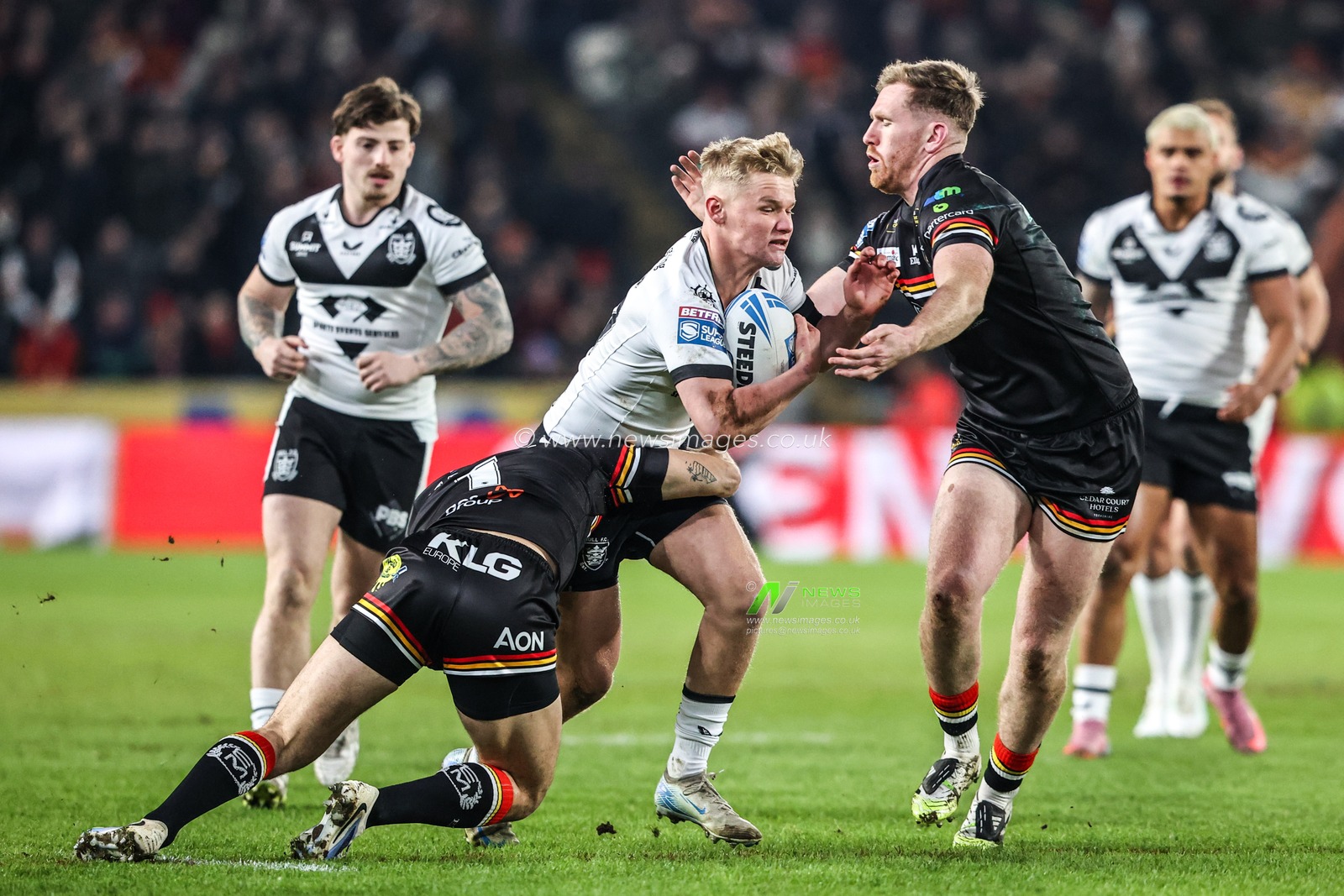 Callum Kemp of Hull FC is tackled by Rowan Milnes of Bradford Bulls and Caleb Aekins of Bradford Bulls during the Betfred Super League round 1 match Hull FC vs Bradford Bulls at MKM Stadium, Hull, United Kingdom on 14 February 2026

(Photo by Alfie Cosgrove/News Images)