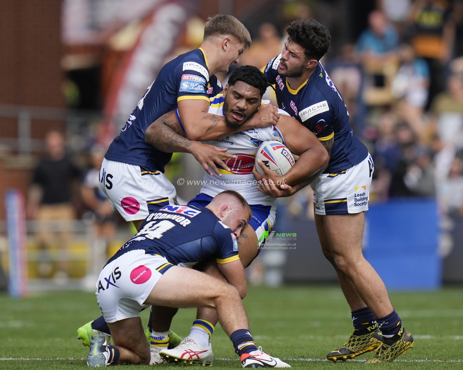 Tom Mikaele #18 of Warrington Wolves is held by the Leeds Rhinos defence during the Betfred Super League Round 22 match Leeds Rhinos vs Warrington Wolves at Headingley Stadium, Leeds, United Kingdom, 20th August 2023

(Photo by Steve Flynn/News Images)
