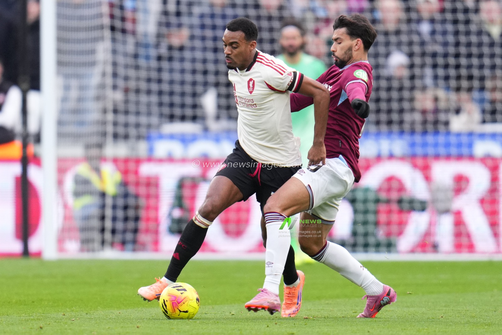 Ryan Gravenberch of Liverpool on the ball under pressure from Lucas Paqueta of West Ham United during the Premier League match West Ham United vs Liverpool at London Stadium, London, United Kingdom, 30th November 2025

(Photo by Harvey Murphy/News Images)

*** GER AUT SUI OUT ***