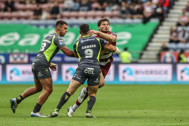 Ethan Havard of Wigan Warriors is tackled by Benjamin Garcia of Catalan Dragons during the Betfred Super League round 20 match Wigan Warriors vs Catalans Dragons at The Brick Community Stadium, Wigan, United Kingdom, 25th July 2025

(Photo by Alfie Cosgrove/News Images)