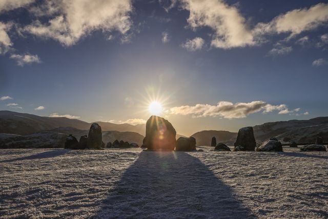 Sun shines over Castlerigg Stone cricle in the lake District