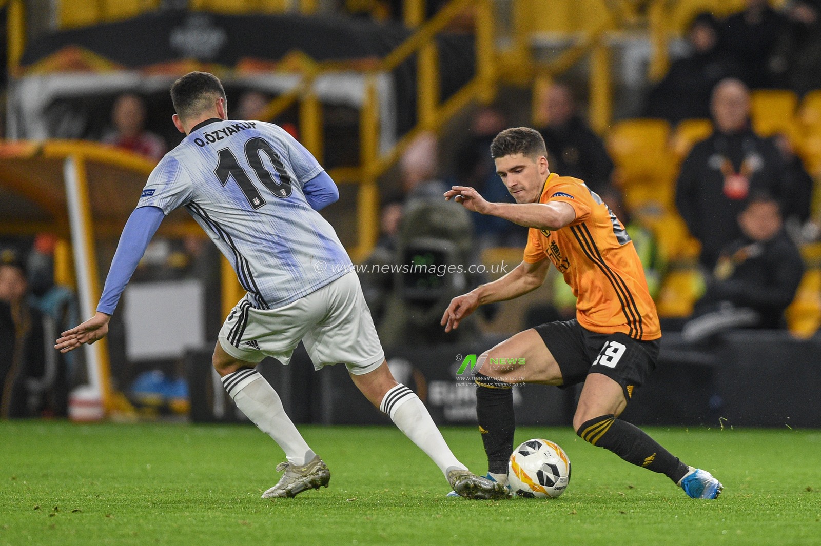 12th December 2019, Molineux, Wolverhampton, England; UEFA Europa League, Wolverhampton Wanderers v Besiktas : Ruben Vinagre (29) of Wolverhampton Wanderers holds the ball as Oguzhan Ozyakup (10) of Besiktas challenges 

Credit: Richard Long/News Images