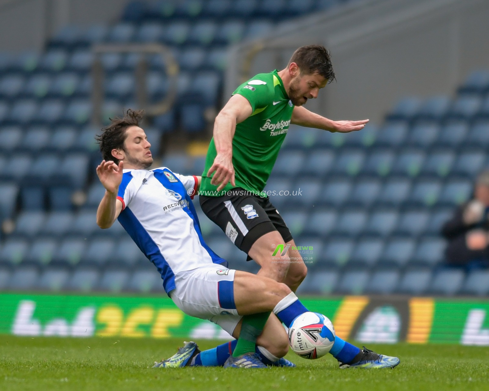 Lewis Travis #27 of Blackburn Rovers fouls Lukas Jutkiewicz #10 of Birmingham City