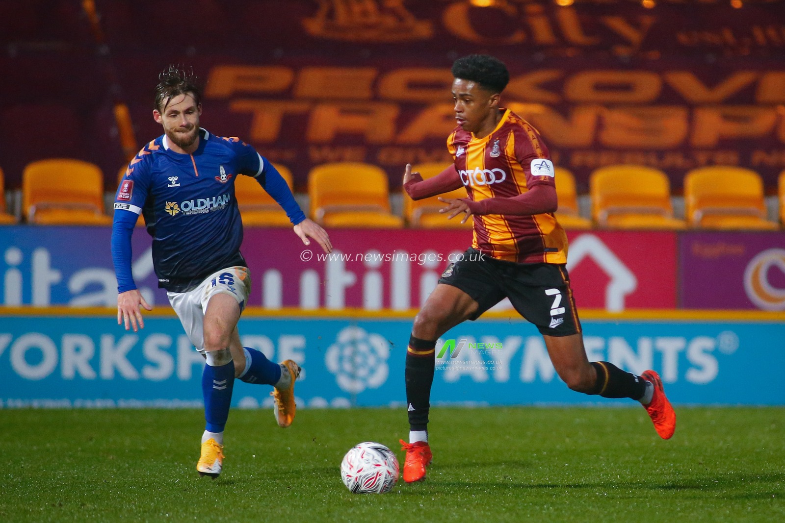 Bryce Hosannah #2 of Bradford City on the attack against  Conor McAleny #18 of Oldham Athletic.