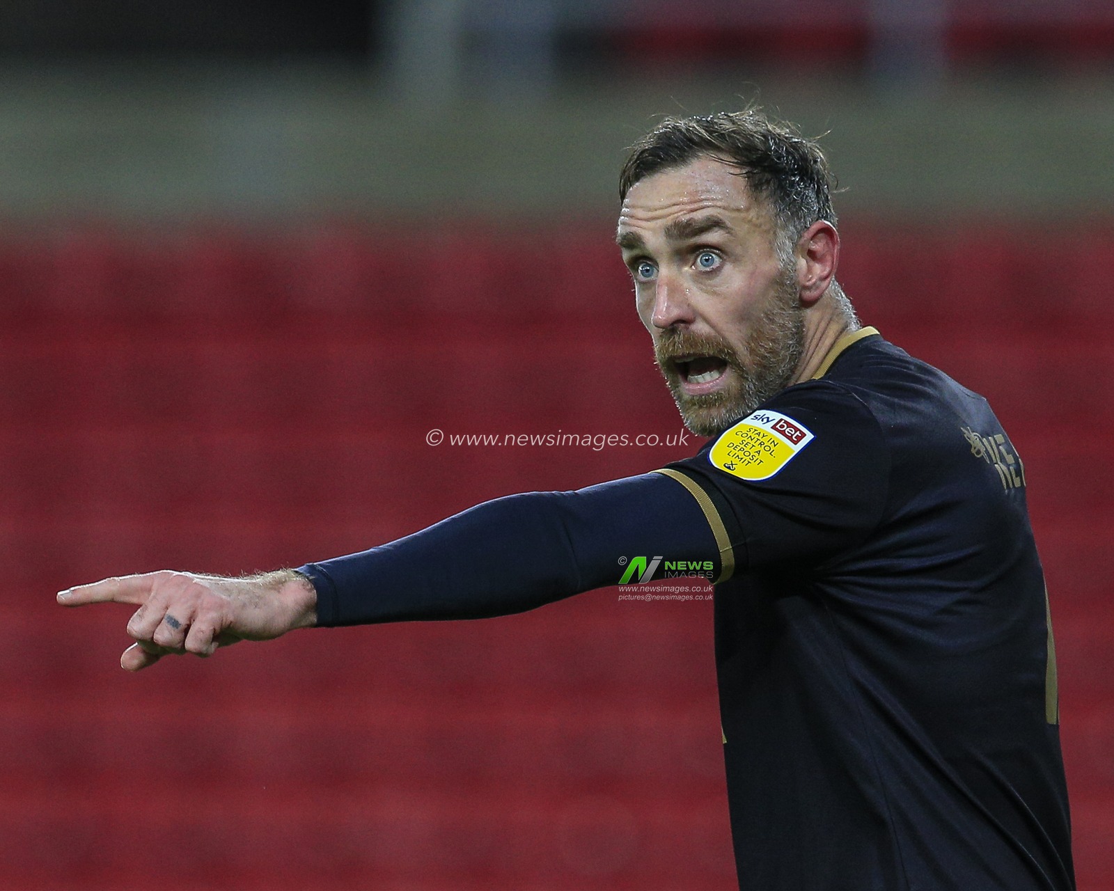 Richard Keogh #4 of Milton Keynes Dons gives his team instructions