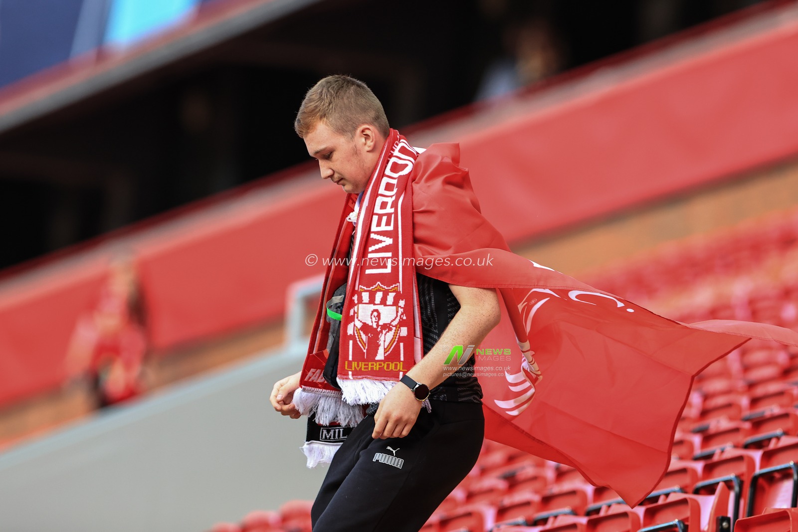 A Liverpool fan inside Anfield as the gates open for this evenings game