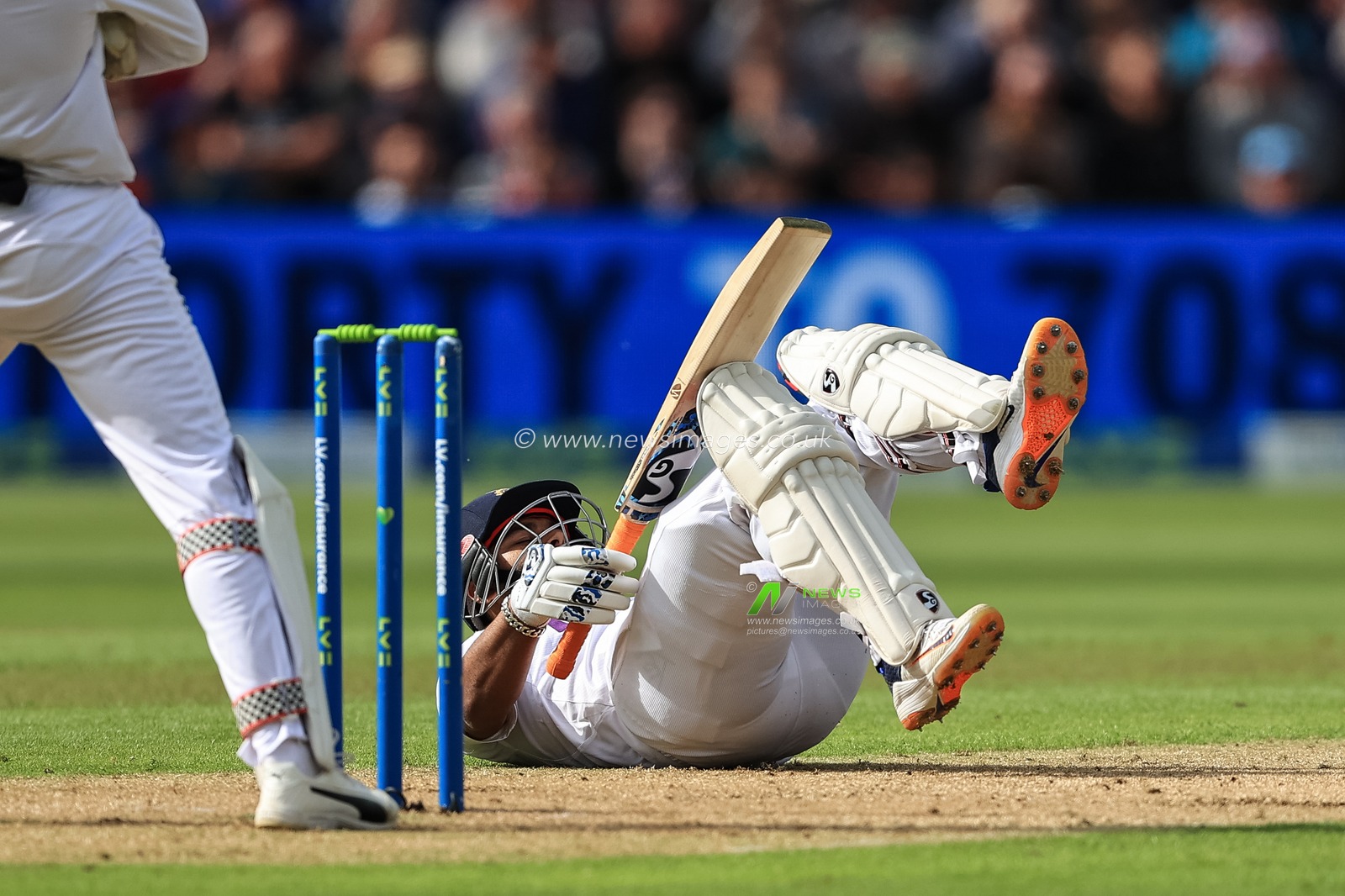 Rishabh Pant of India ends up on his back after hitting a four