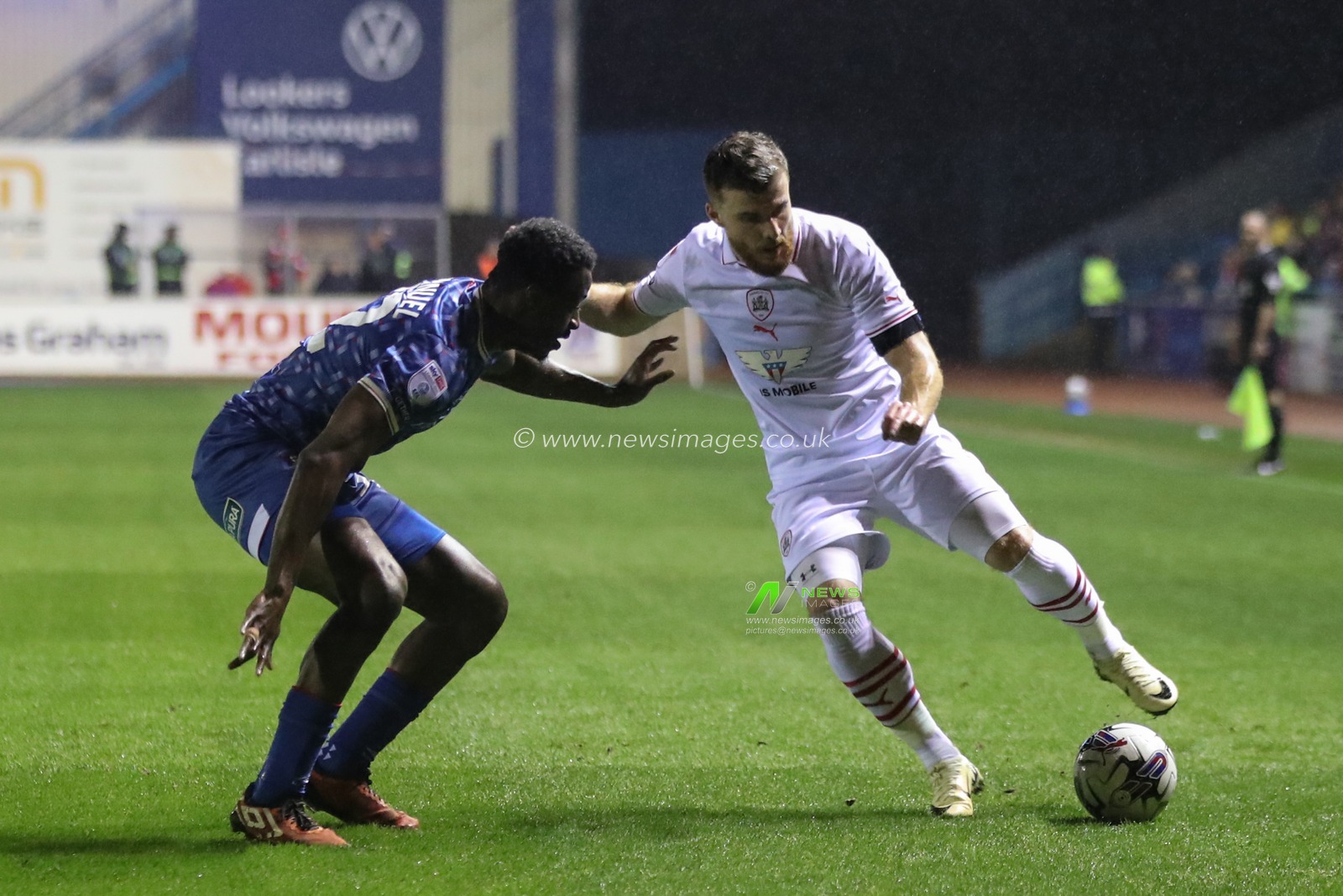 Josh Emmanuel of Carlisle United and Nicky Cadden of Barnsley during the Sky Bet League 1 match Carlisle United vs Barnsley at Brunton Park, Carlisle, United Kingdom, 12th March 2024

(Photo by Alfie Cosgrove/News Images)
