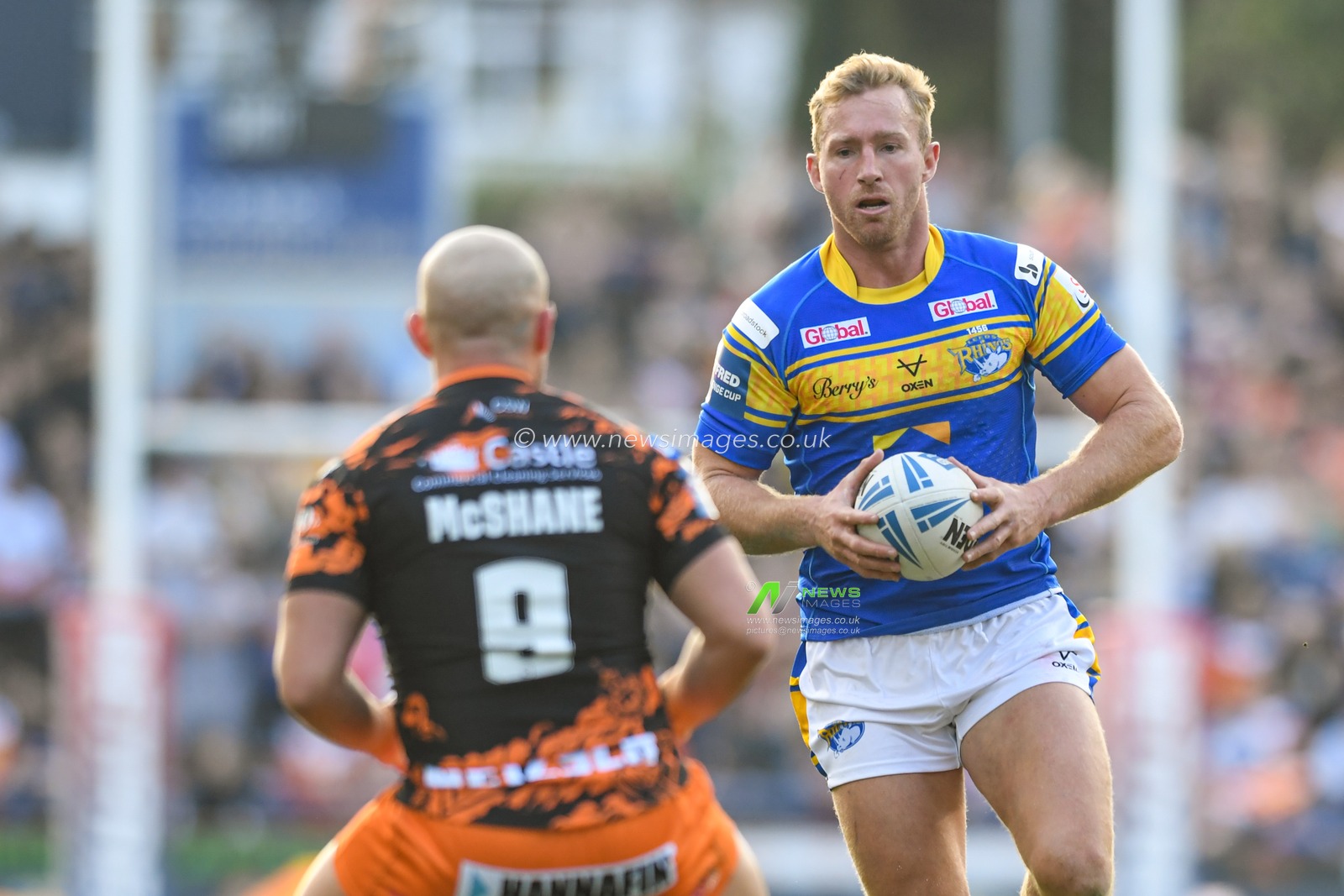 Matt Prior #10 of Leeds Rhinos looks for a way past Paul McShane #9 of Castleford Tigers