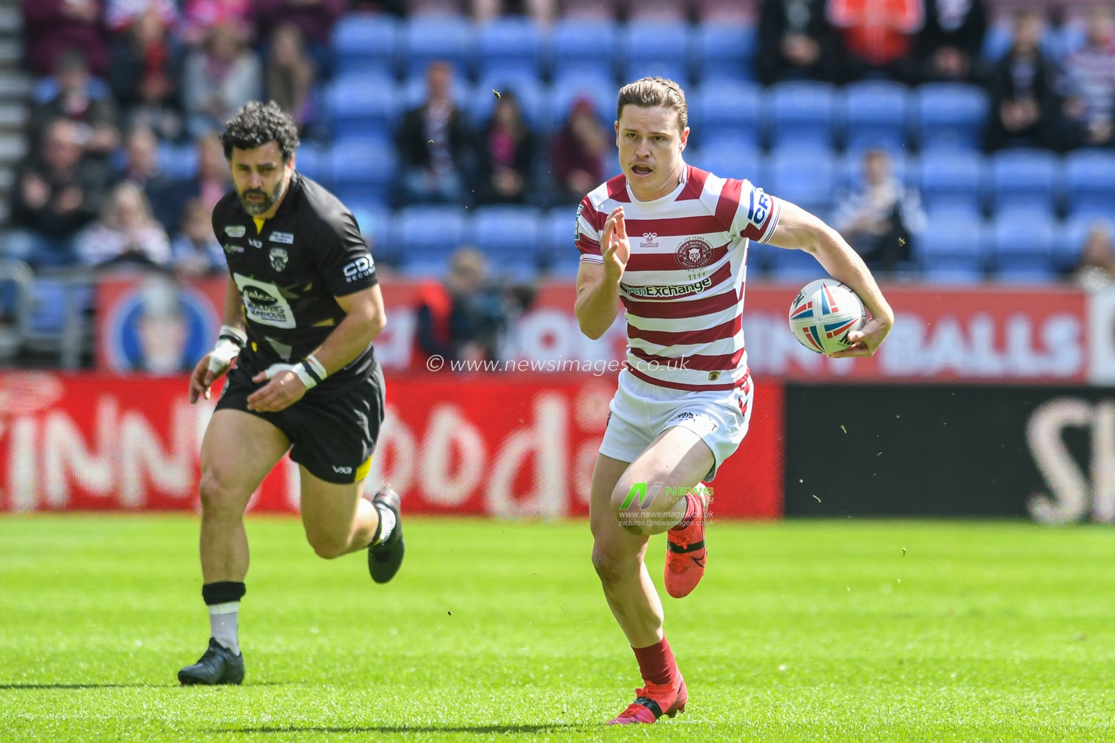 Jai Field #23 of Wigan Warriors runs forward with the ball