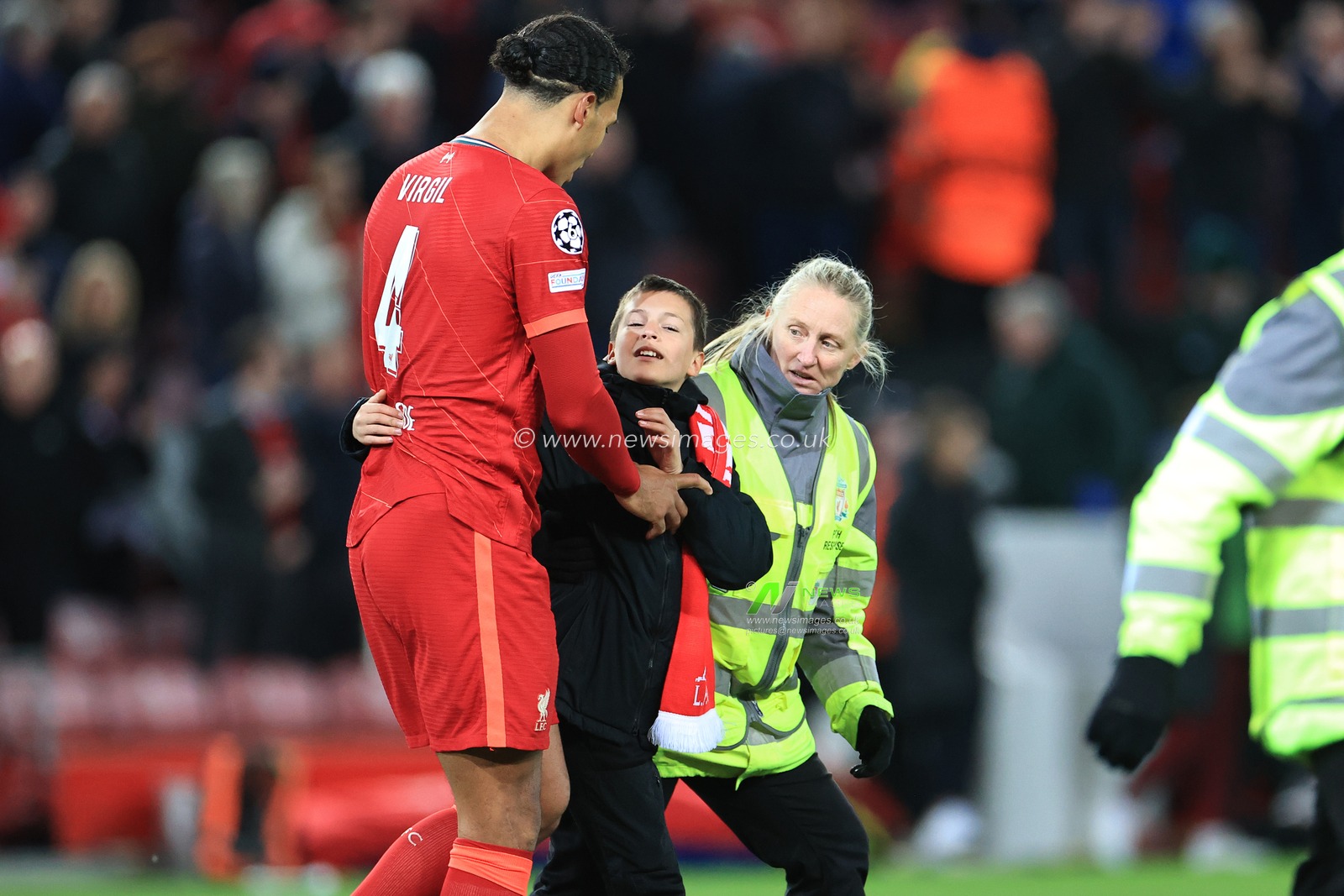 Virgil van Dijk #4 of Liverpool with a young fan