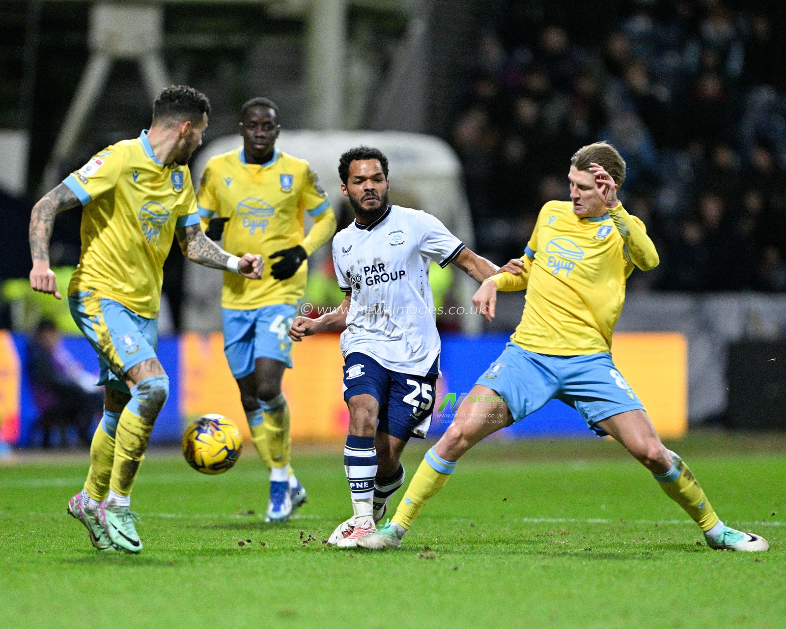 Duane Holmes 25# of Preston North End gets tackled by George Byers #8 of Sheffield Wednesday, during the Sky Bet Championship match Preston North End vs Sheffield Wednesday at Deepdale, Preston, United Kingdom, 29th December 2023

(Photo by Cody Froggatt/News Images)