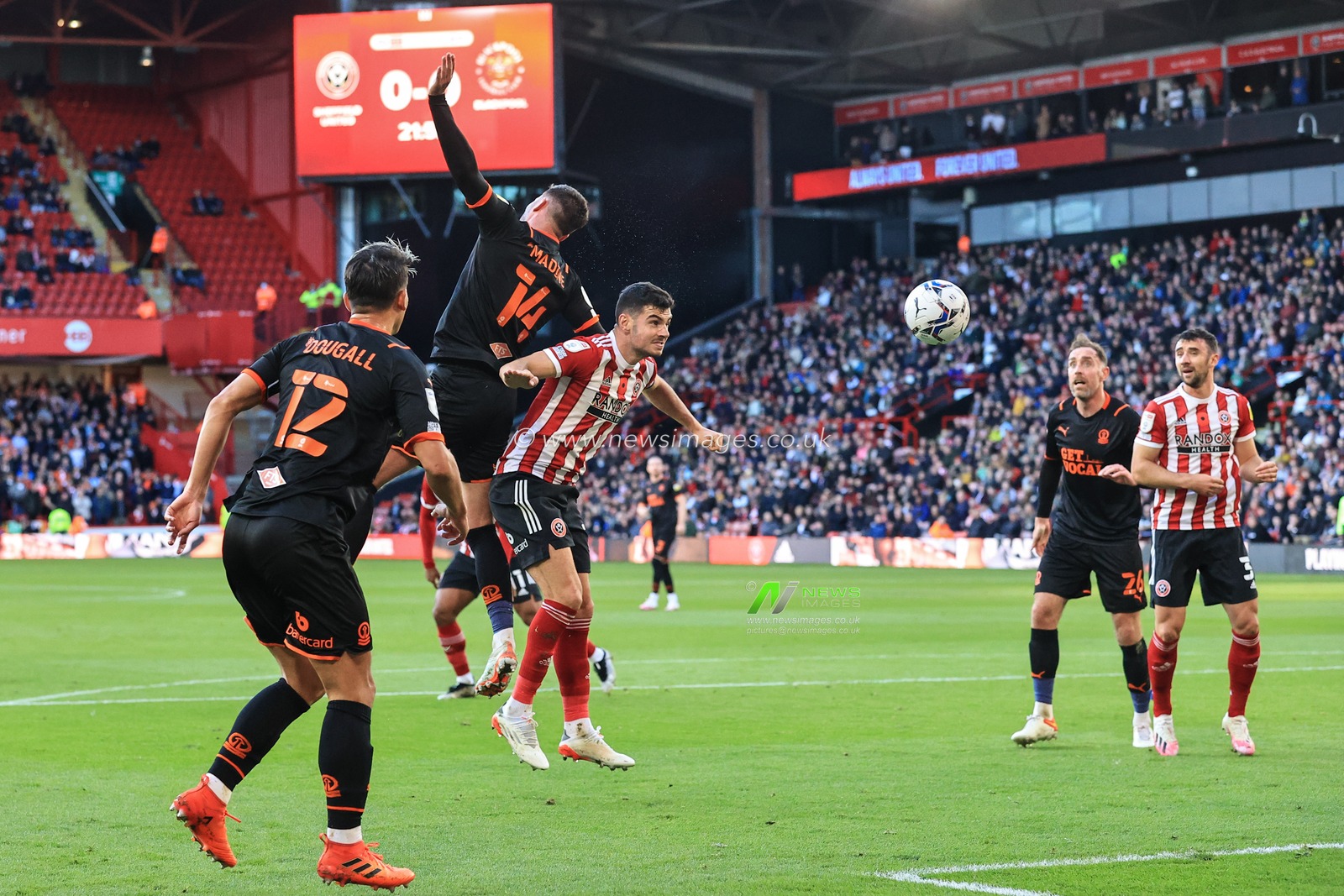 Gary Madine #14 of Blackpool heads on goal from a corner