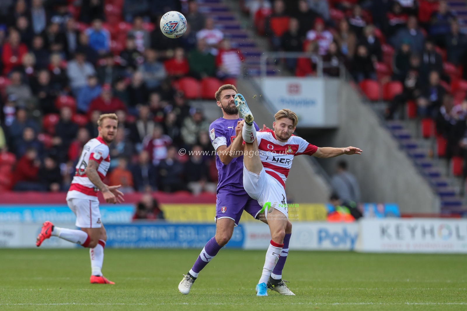 7th September 2019, Keepmoat Stadium, Doncaster, England; Sky Bet League One Football, Doncaster Rovers vs Rotherham United ; Alfie May (19) of Doncaster Rovers clears the ball with a overhead kick and just misses Clark Robertson (15) of Rotherham Unitedâ€™s face with his boot 



Credit: Mark Cosgrove/News Images

English Football League images are subject to DataCo Licence