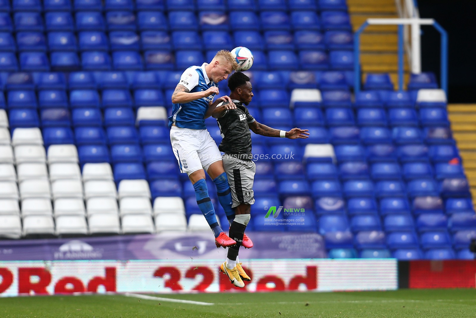 Kristian Pederson (3) of Birmingham City and Moses Odubajo (22) of Sheffield Wednesday compete for the aerial ball