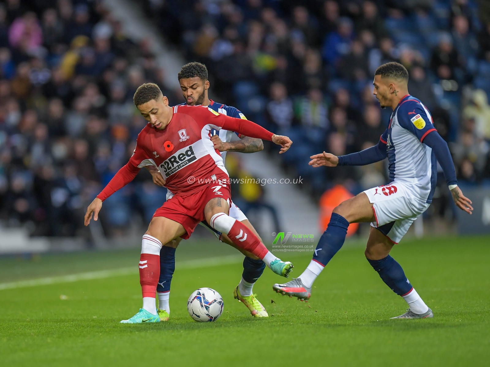 Marcus Tavernier #7 of Middlesbrough under pressure from Darnell Furlong #2 of West Bromwich Albion and Karlan Grant #18 of West Bromwich Albion