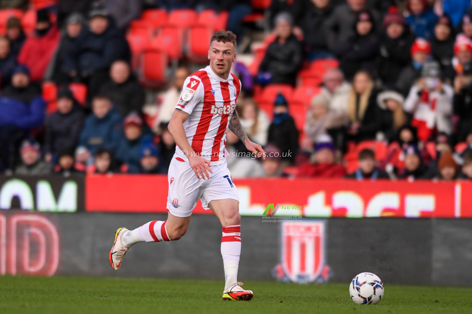 Josh Tymon #14 of Stoke City runs forward with the ball