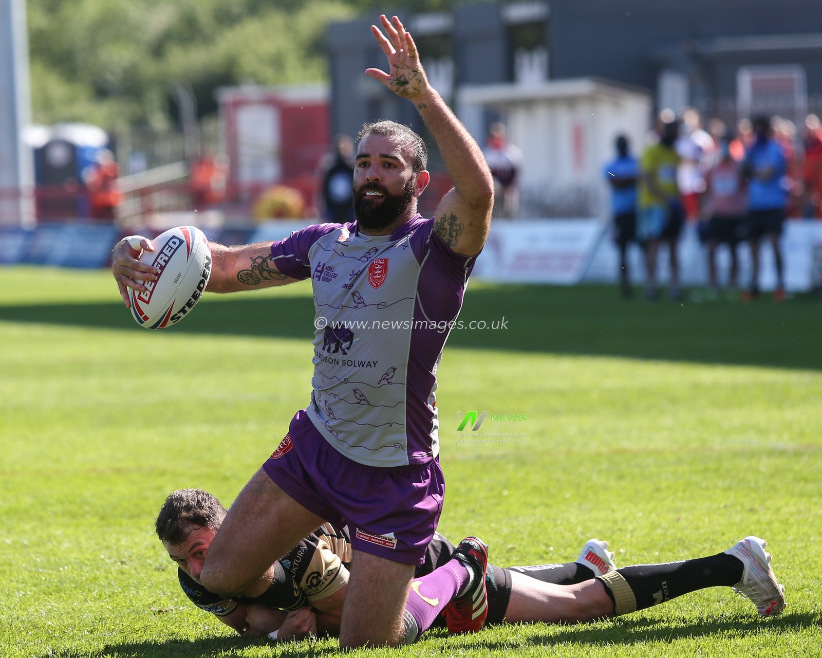 Kane Linnett (12) of Hull KR is tackled by Ryan Brierley (1) of Leigh Centurions