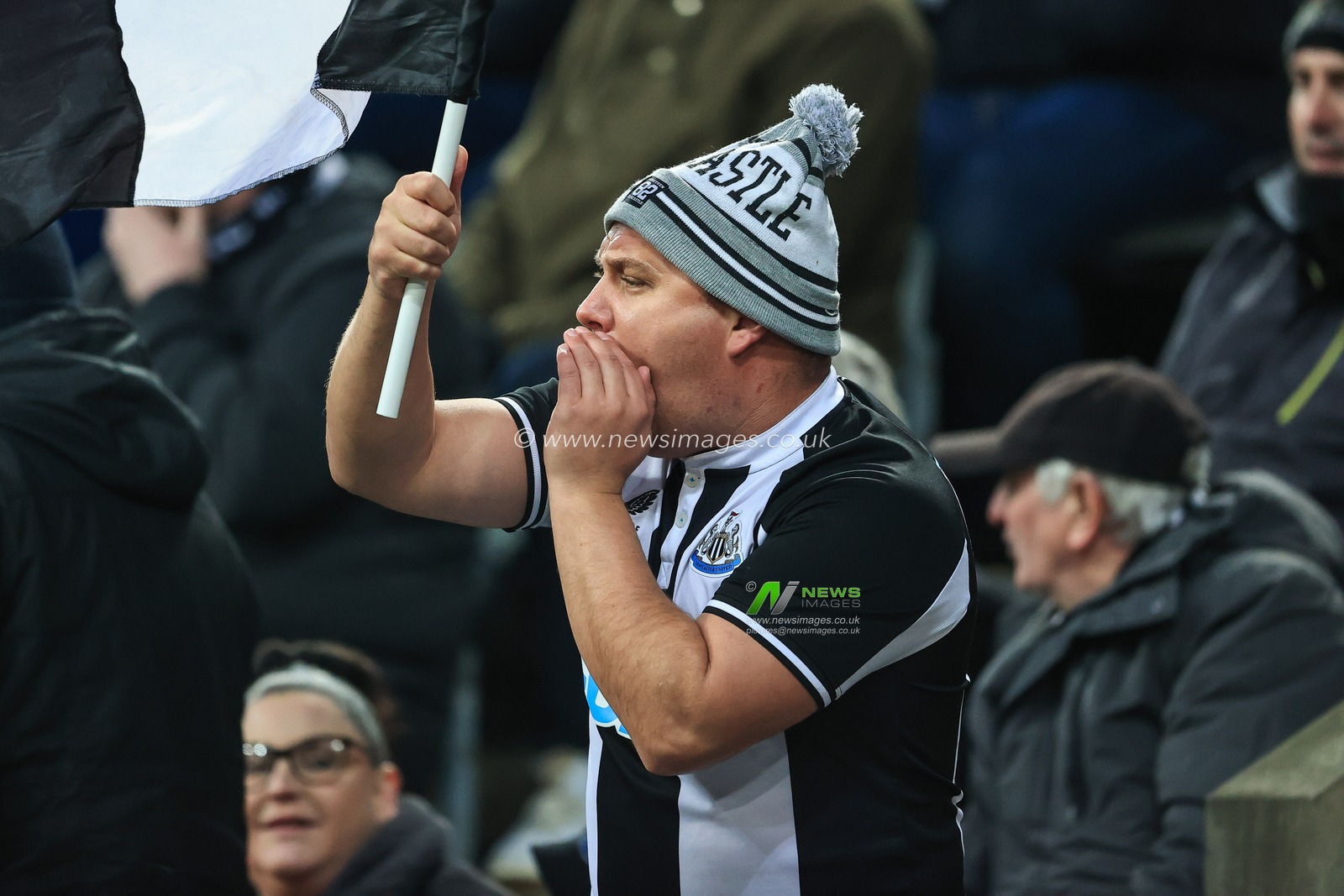 A Newcastle United fans cheers on his side despite being 0-3 down