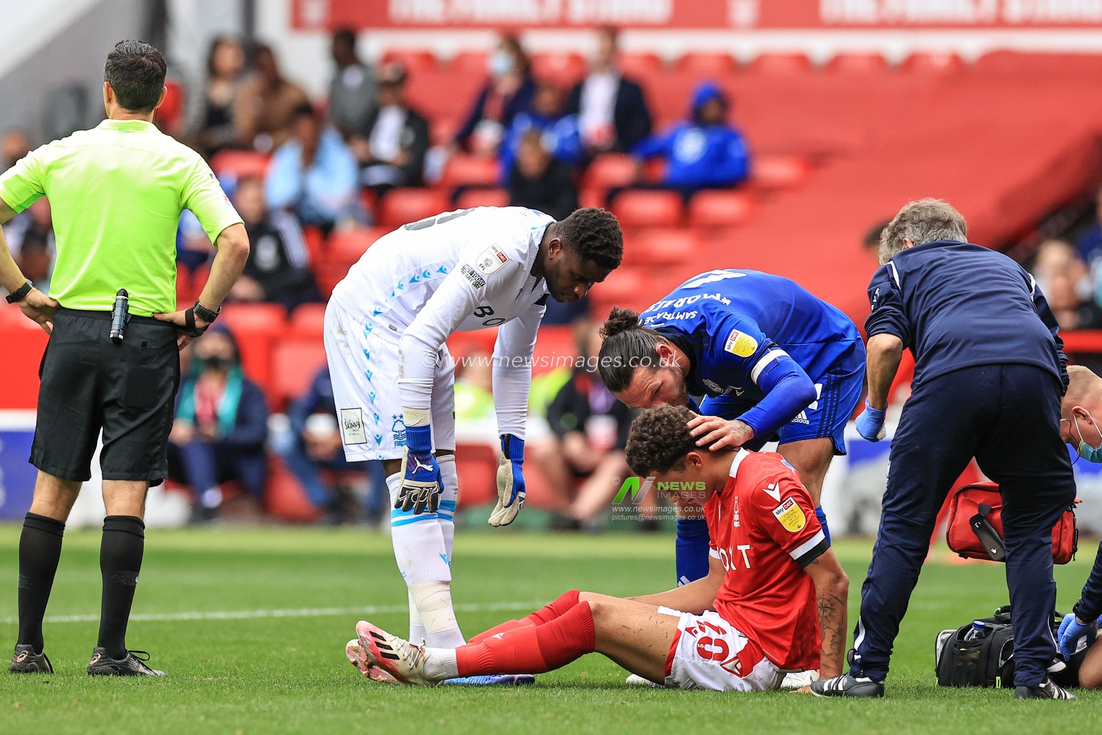 Sean Morrison #4 of Cardiff City checks on Brennan Johnson #20 of Nottingham Forest after he takes a knock on a one on one