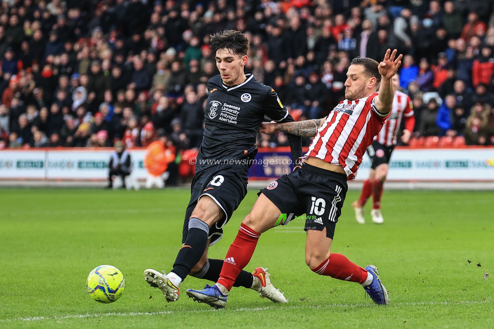 Billy Sharp #10 of Sheffield United is tackled by celebrates his goal to make it Finley Burns #30 of Swansea City