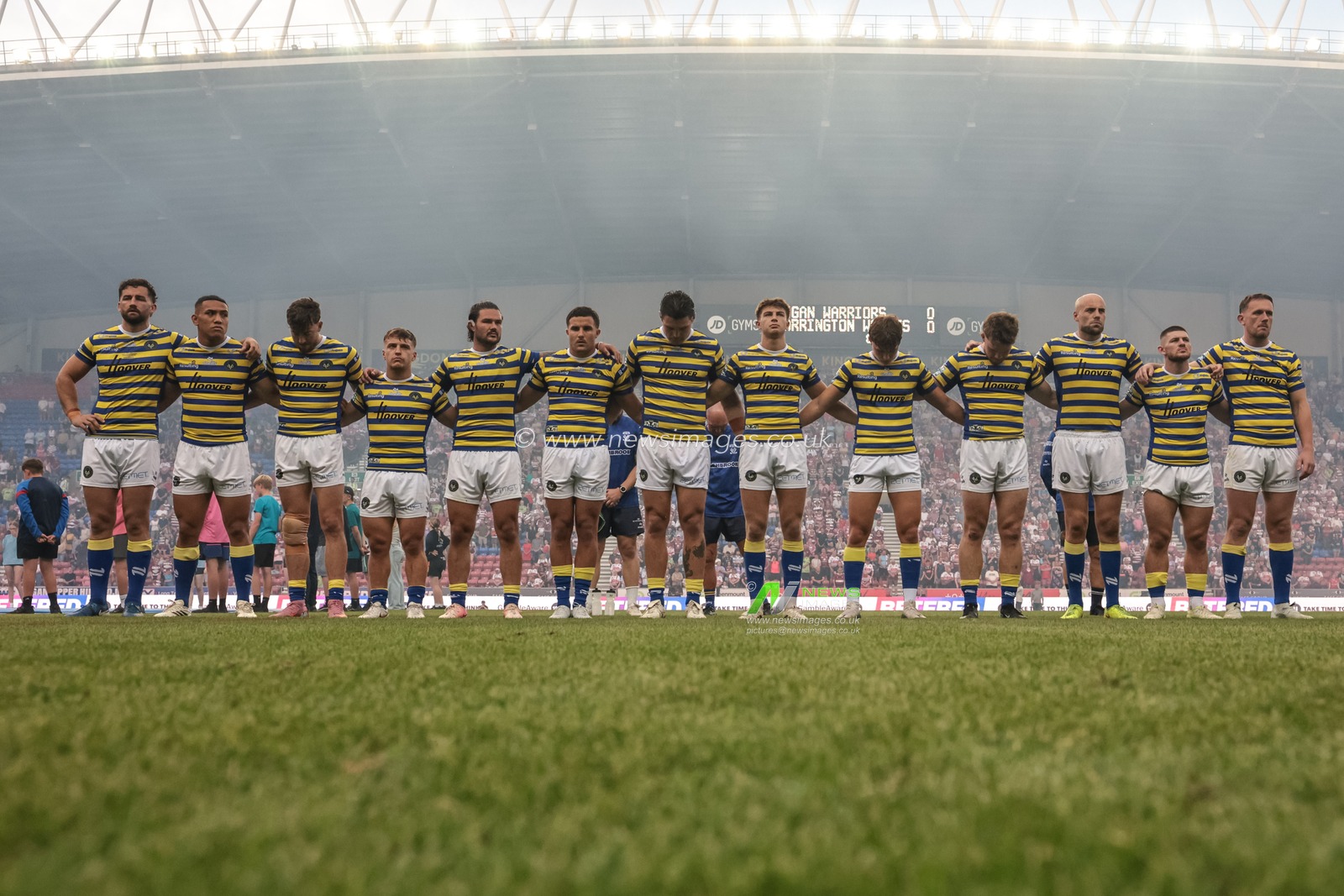 Warrington players arm-in-arm as The Last Post is played as part of Wigans armed forces day during the Betfred Super League round 18 match Wigan Warriors vs Warrington Wolves at The Brick Community Stadium, Wigan, United Kingdom on 10 July 2026

(Photo by Mark Cosgrove/News Images)