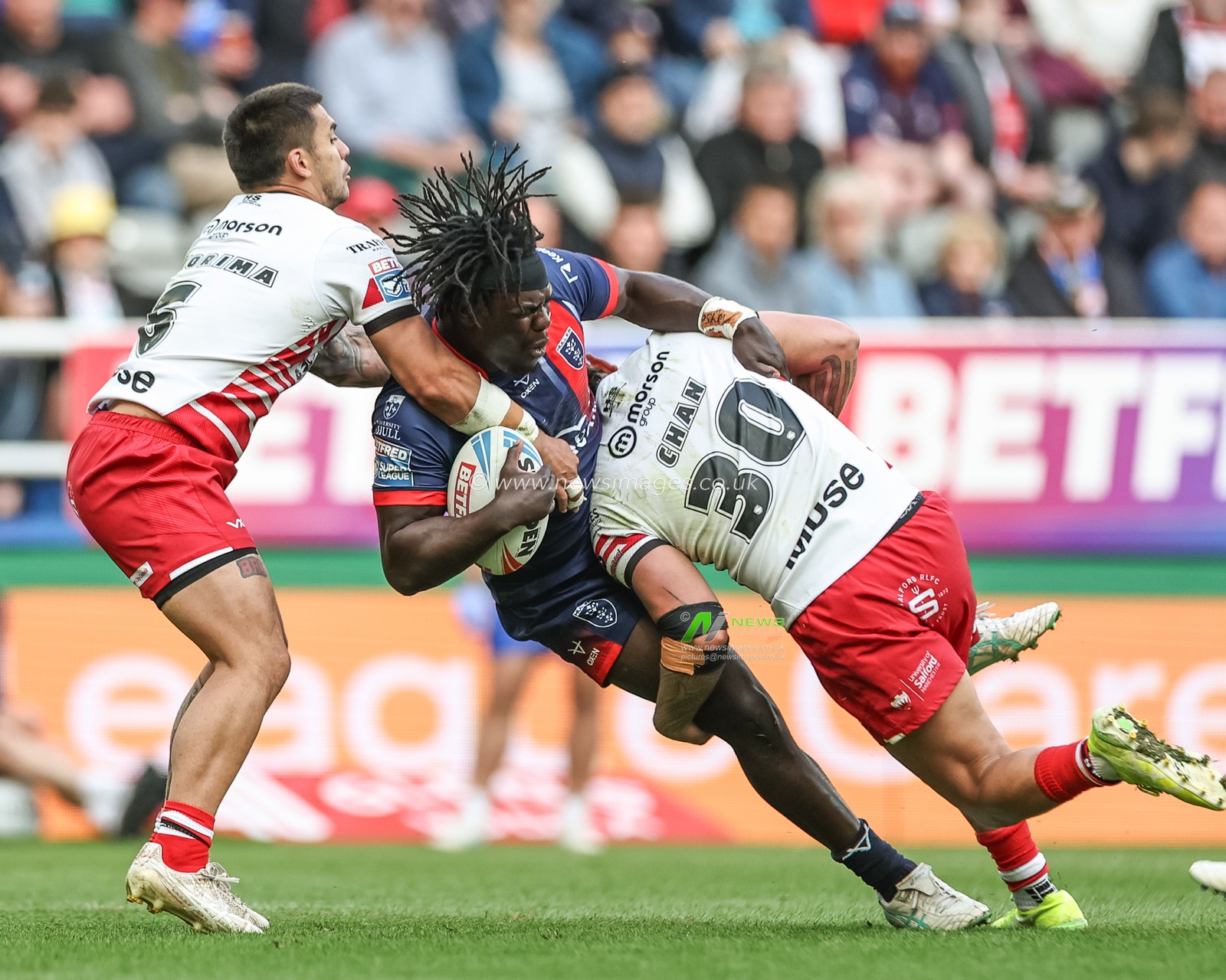 Eribe Doro of Hull KR is tackled by Jayden Nikorima of Salford Red Devils and Tiaki Chan of Salford Red Devils during the Betfred Magic Weekend 2025 match Hull KR vs Salford Red Devils at St. James's Park, Newcastle, United Kingdom, 3rd May 2025

(Photo by Mark Cosgrove/News Images)