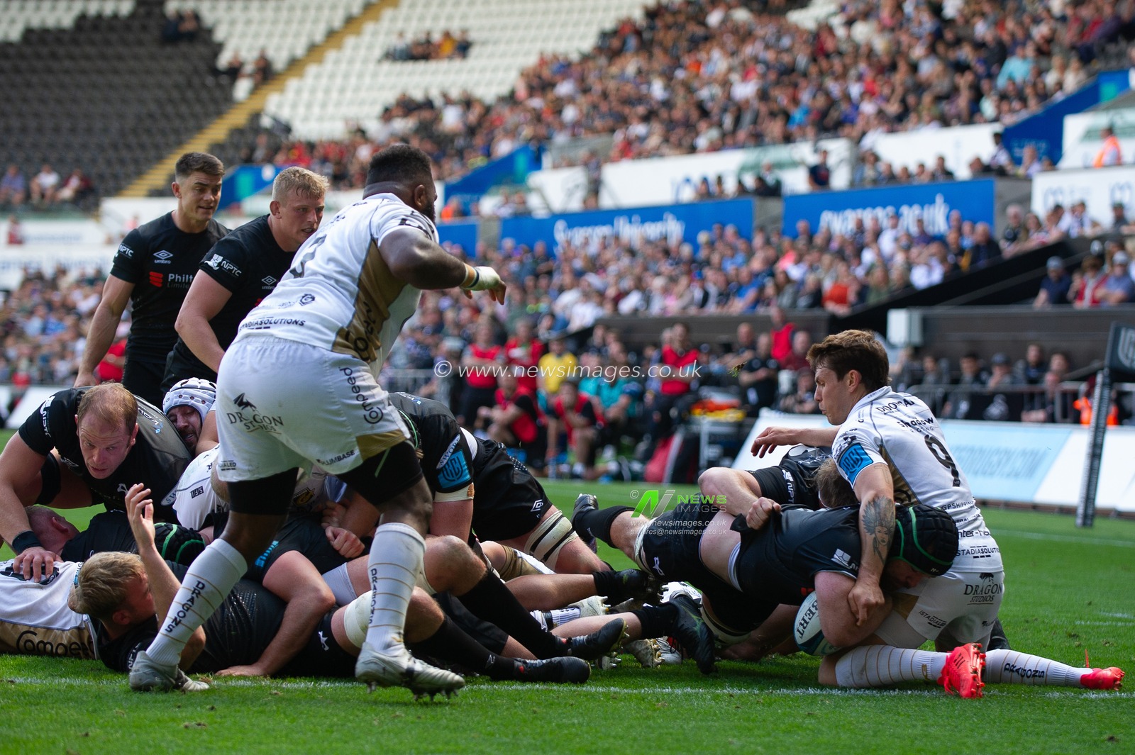 Morgan Morris of Ospreys, goes over to score his first try