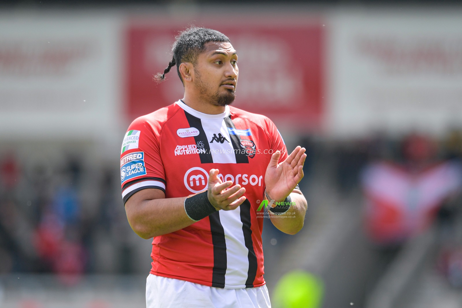 Pauli Pauli (12) of Salford Red Devils applauds the home supporters during the game