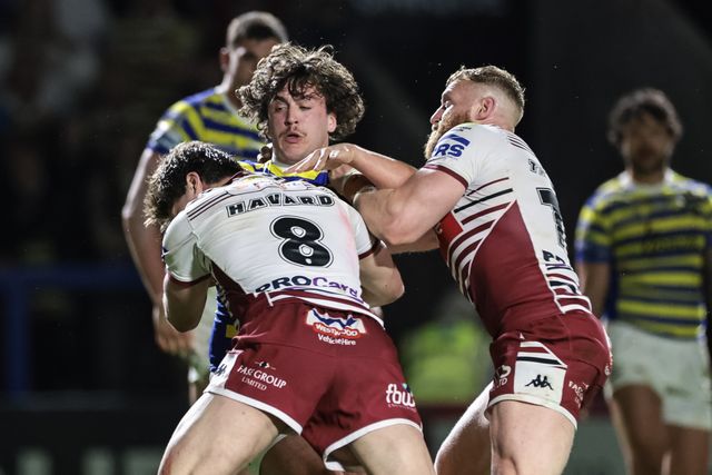 Max Wood of Warrington Wolves is tackled by Ethan Havard of Wigan Warriors and Luke Thompson of Wigan Warriors during the Betfred Super League round 9 match Warrington Wolves vs Wigan Warriors at The Halliwell Jones Stadium, Warrington, United Kingdom on 24 April 2026

(Photo by Mark Cosgrove/News Images)