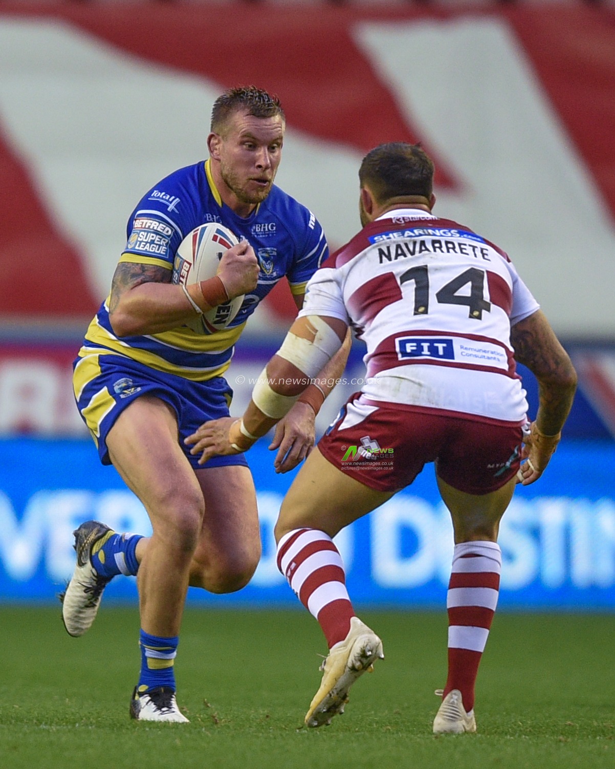 16th August 2019 , DW Stadium, Wigan, England;  Betfred Super League, Round 26, Wigan Warriors vs Warrington Wolves ; Mike Cooper of Warrington Wolves heads in to the tackle of Romain Navarrete (14) of Wigan Warriors 

Credit: Richard Long/News Images